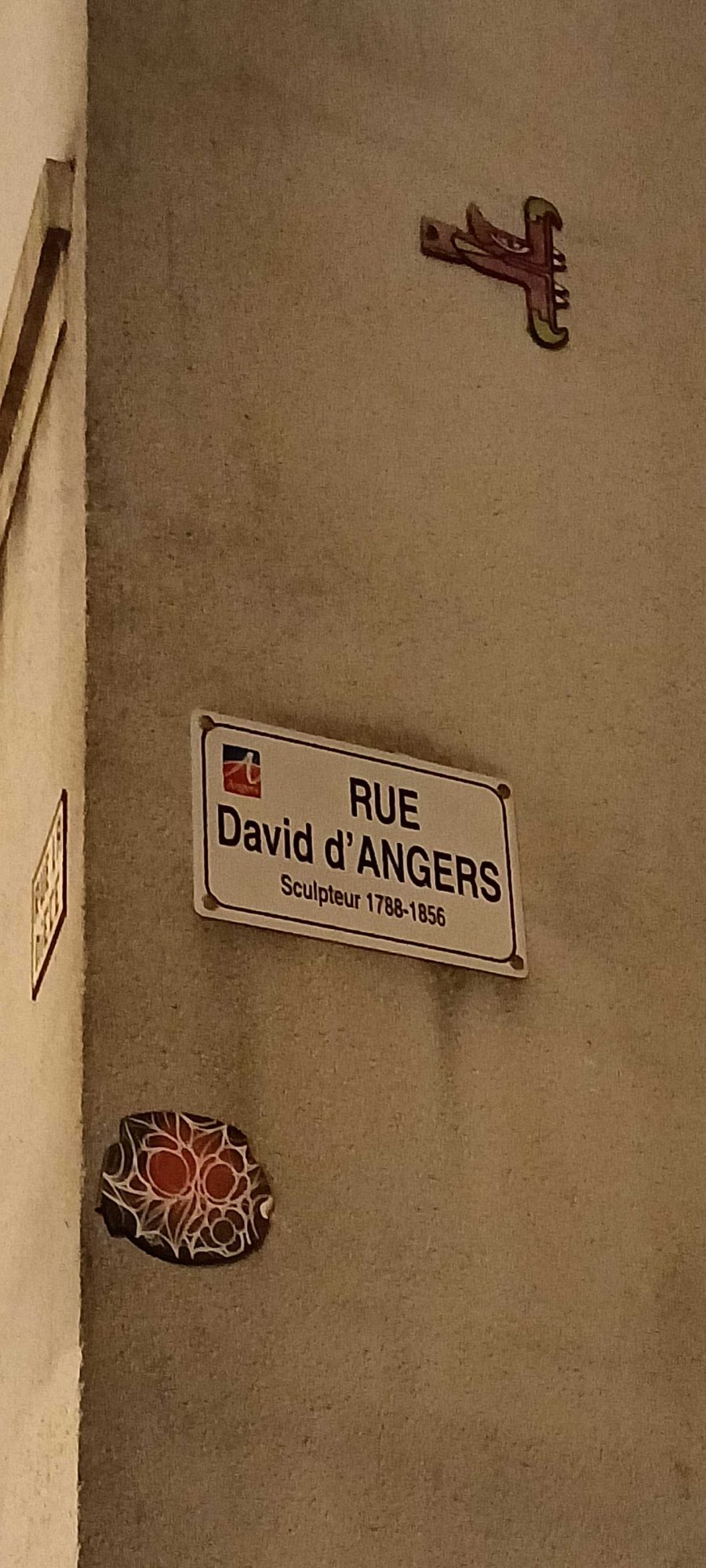 Ceramic Rosette Below the Street Sign — Street art by Oré, Fast Freak in Angers