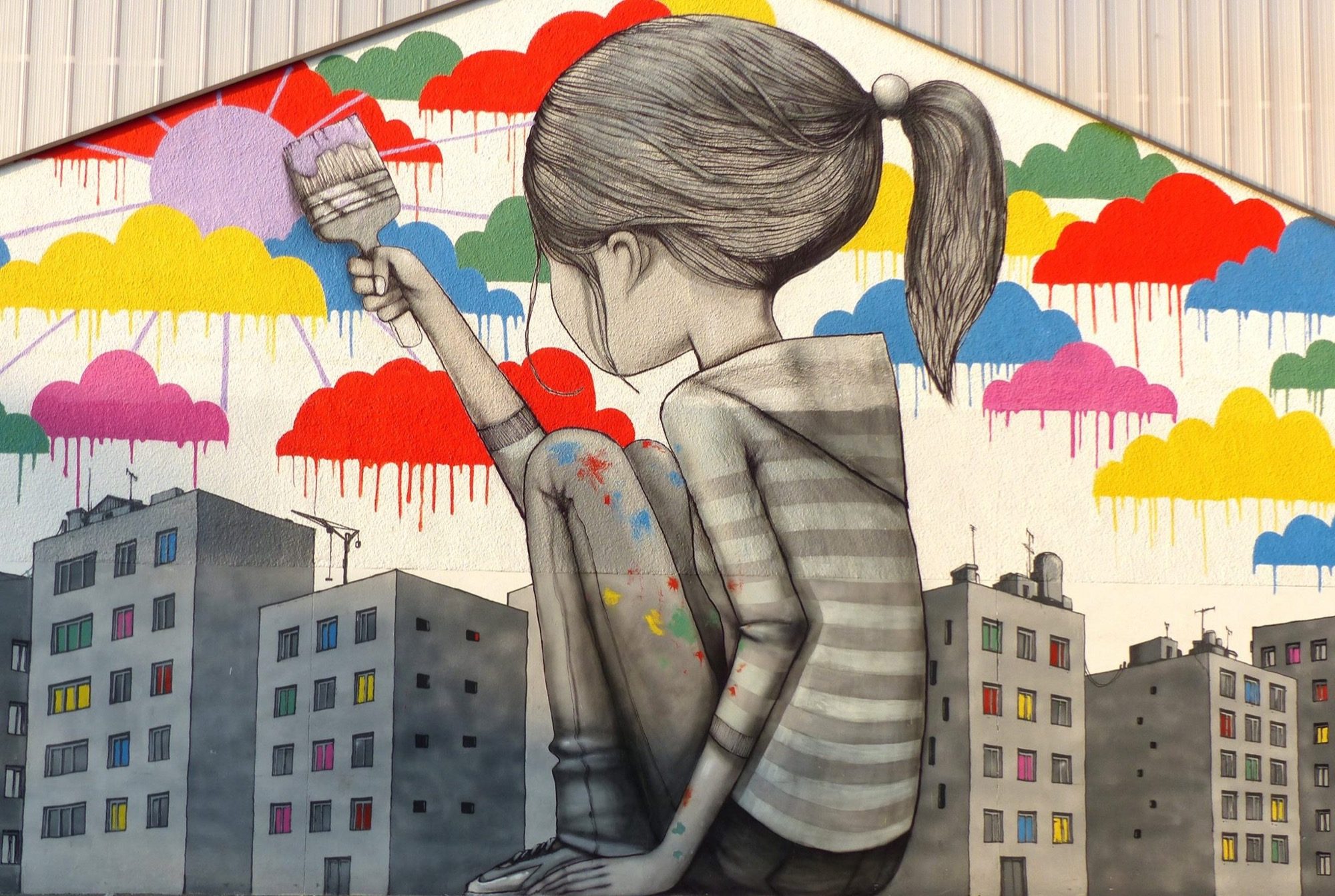 Children with colorful clouds — Street art by Seth in Fleury-les-Aubrais