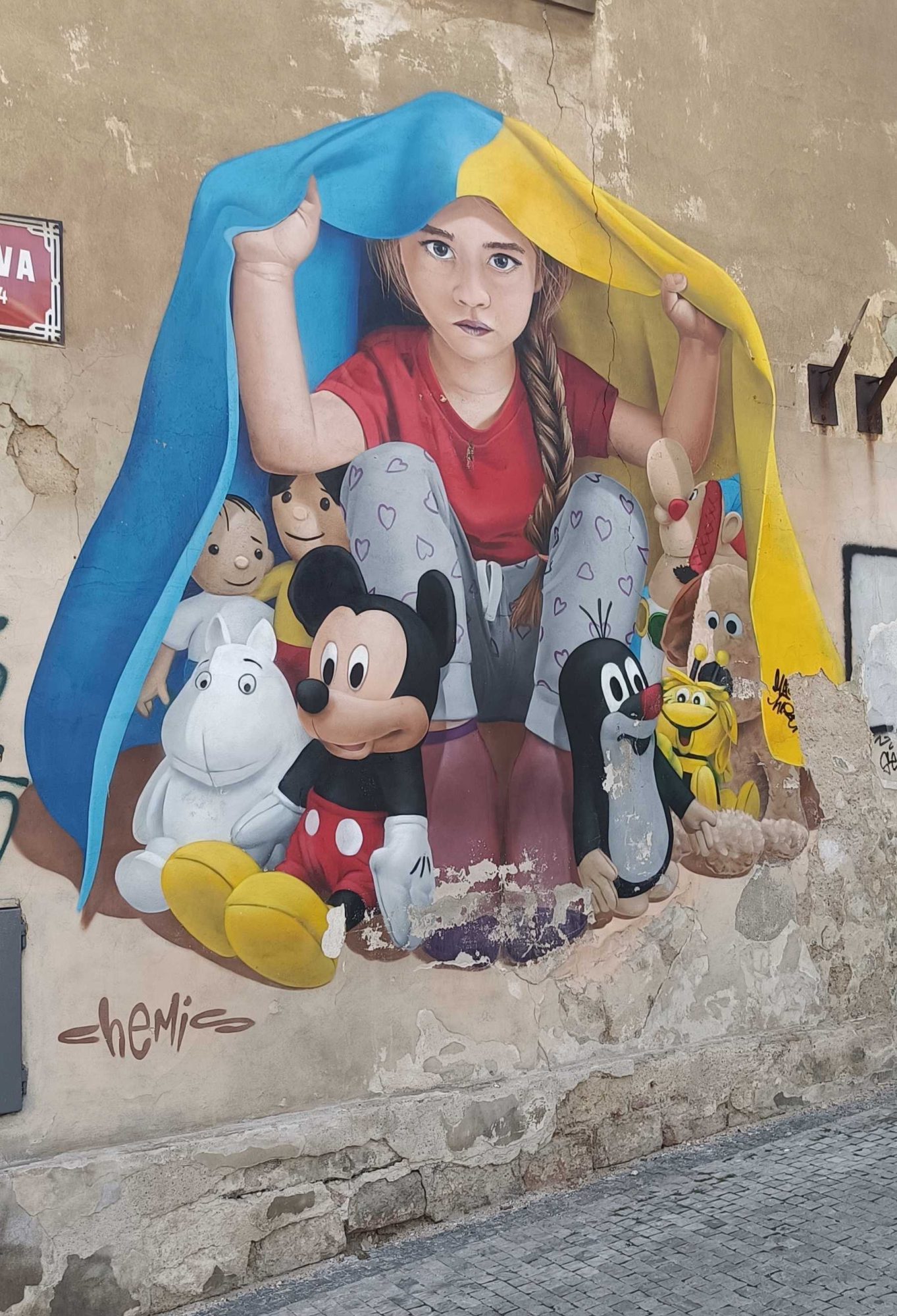 The Girl under the Blue and Yellow Flag — Street art by ChemiS in Prague