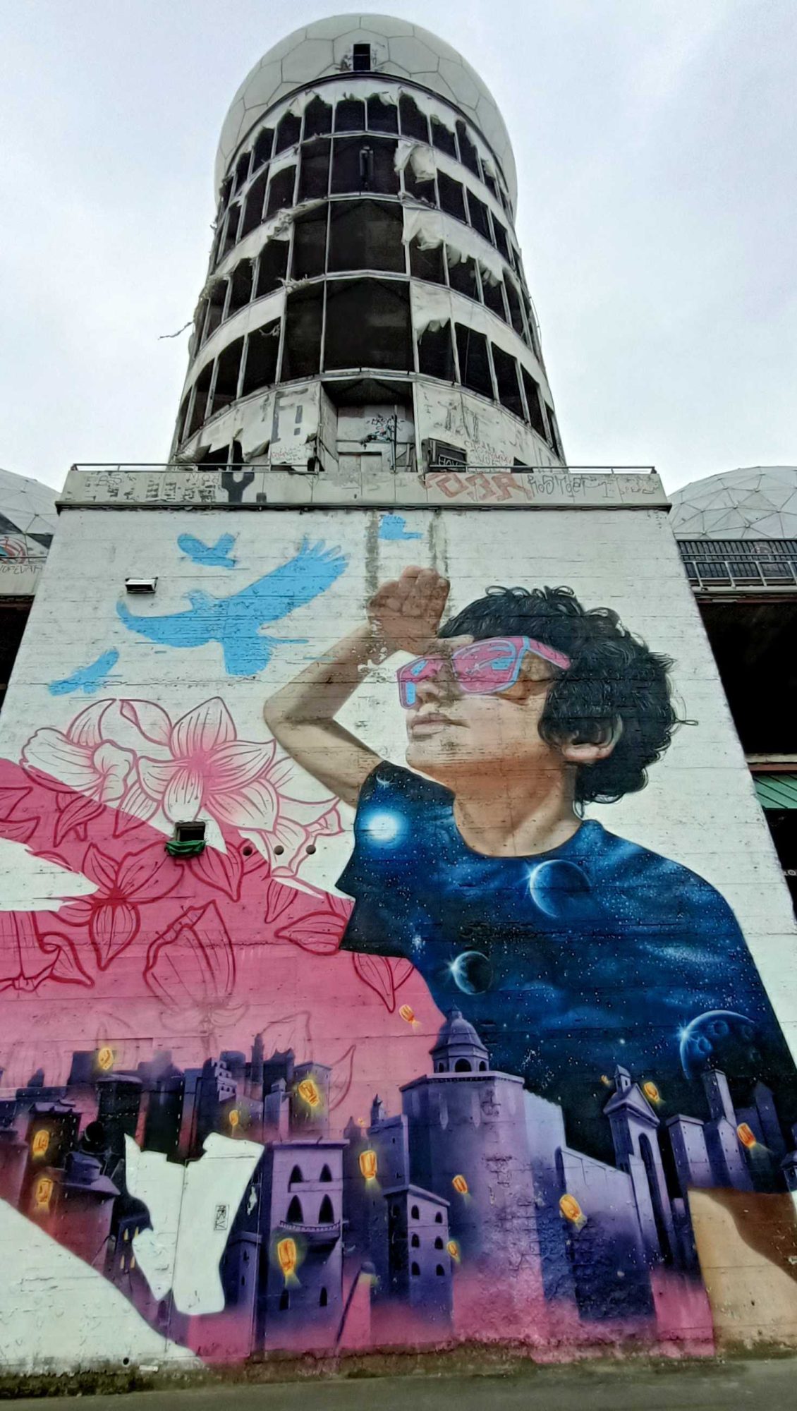 Dreamy Young Man between Flowers and Fantasy City — Street art by MATE in Berlin