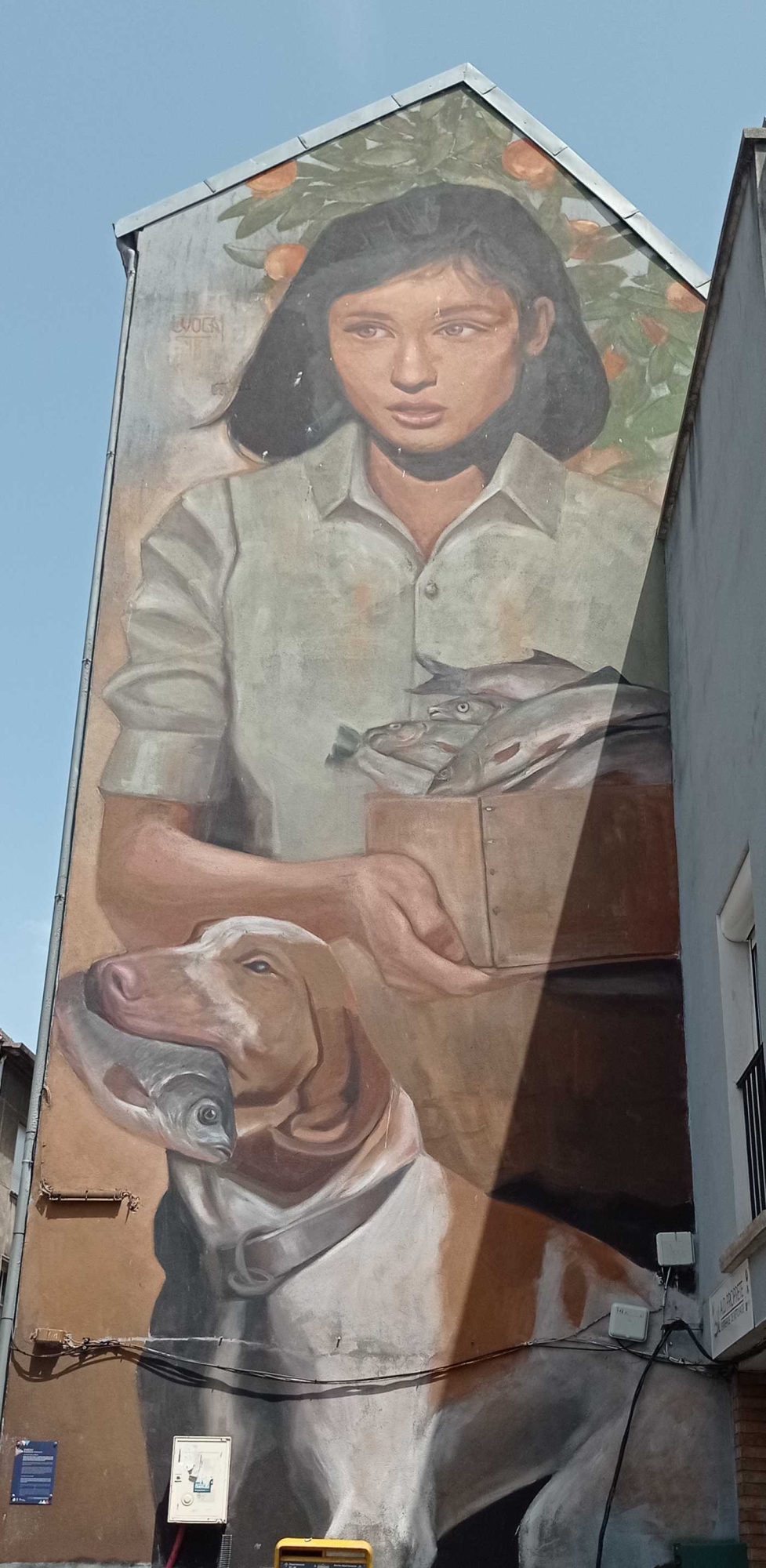 The Girl with a Crate of Fish and Her Dog — Street art in Boulogne-sur-Mer
