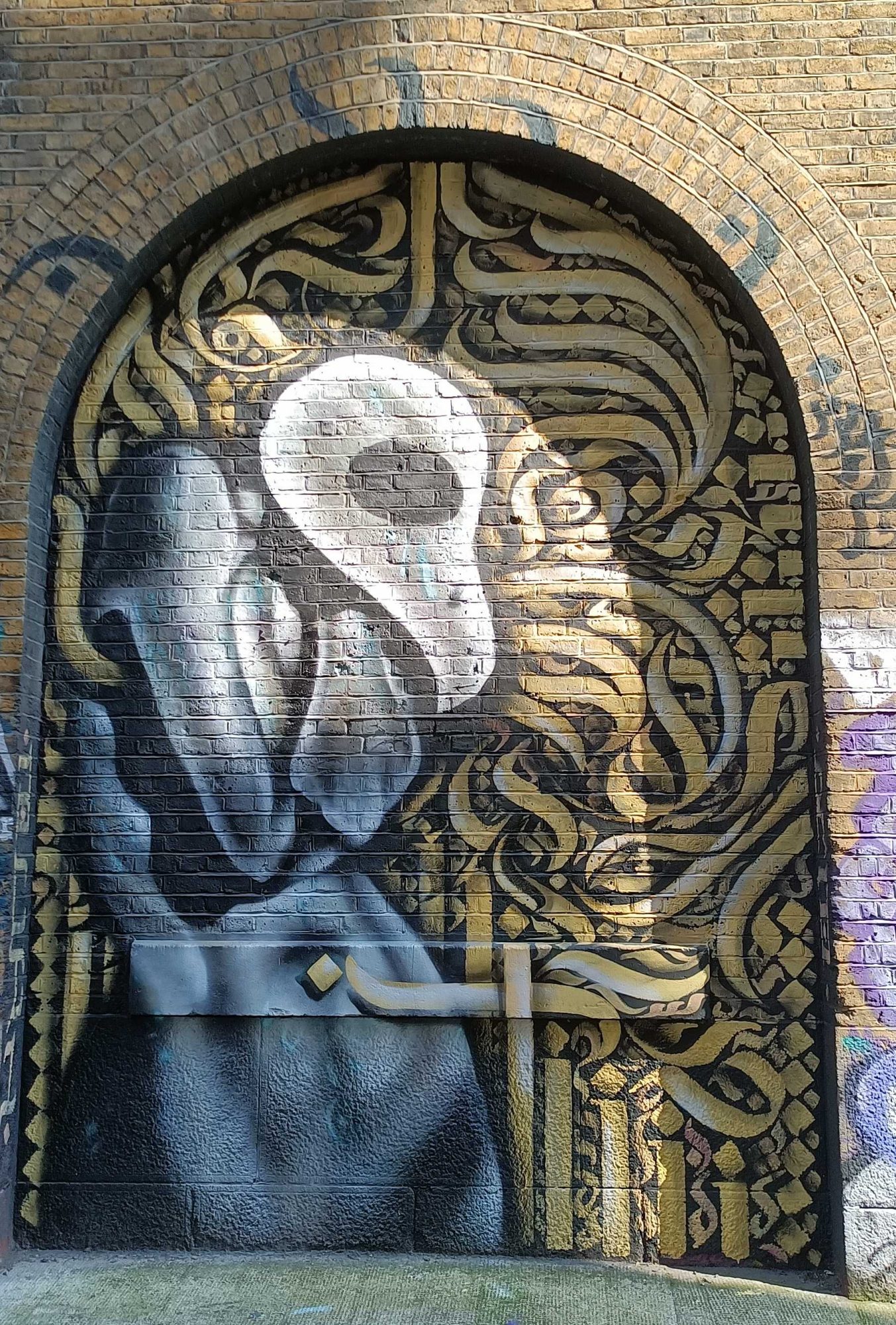 The Skull Figure on Gilded Calligraphy — Street art in London