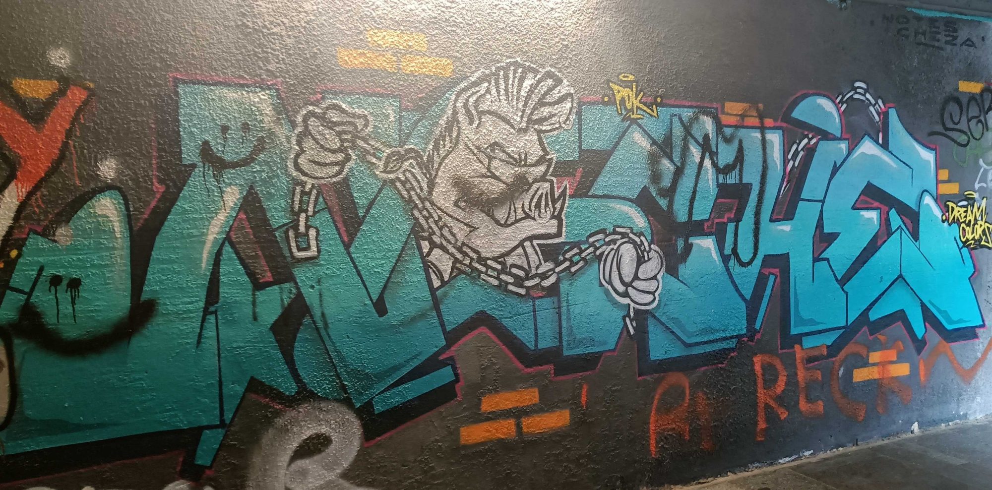 Blue Wildstyle Graffiti with Chained Character — Street art in Prague