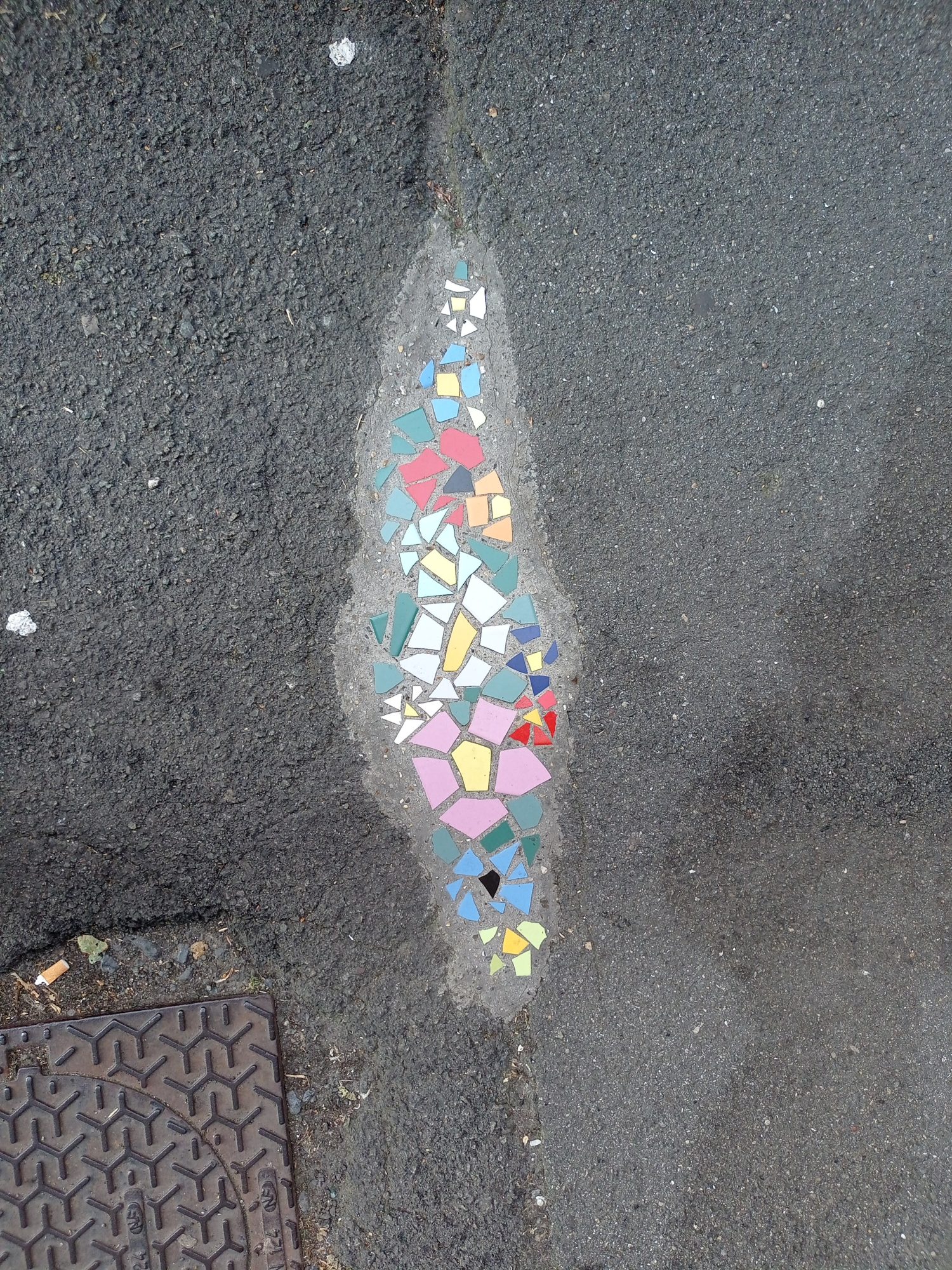 Pothole Filled with Coloured Shards — Street art in Lille