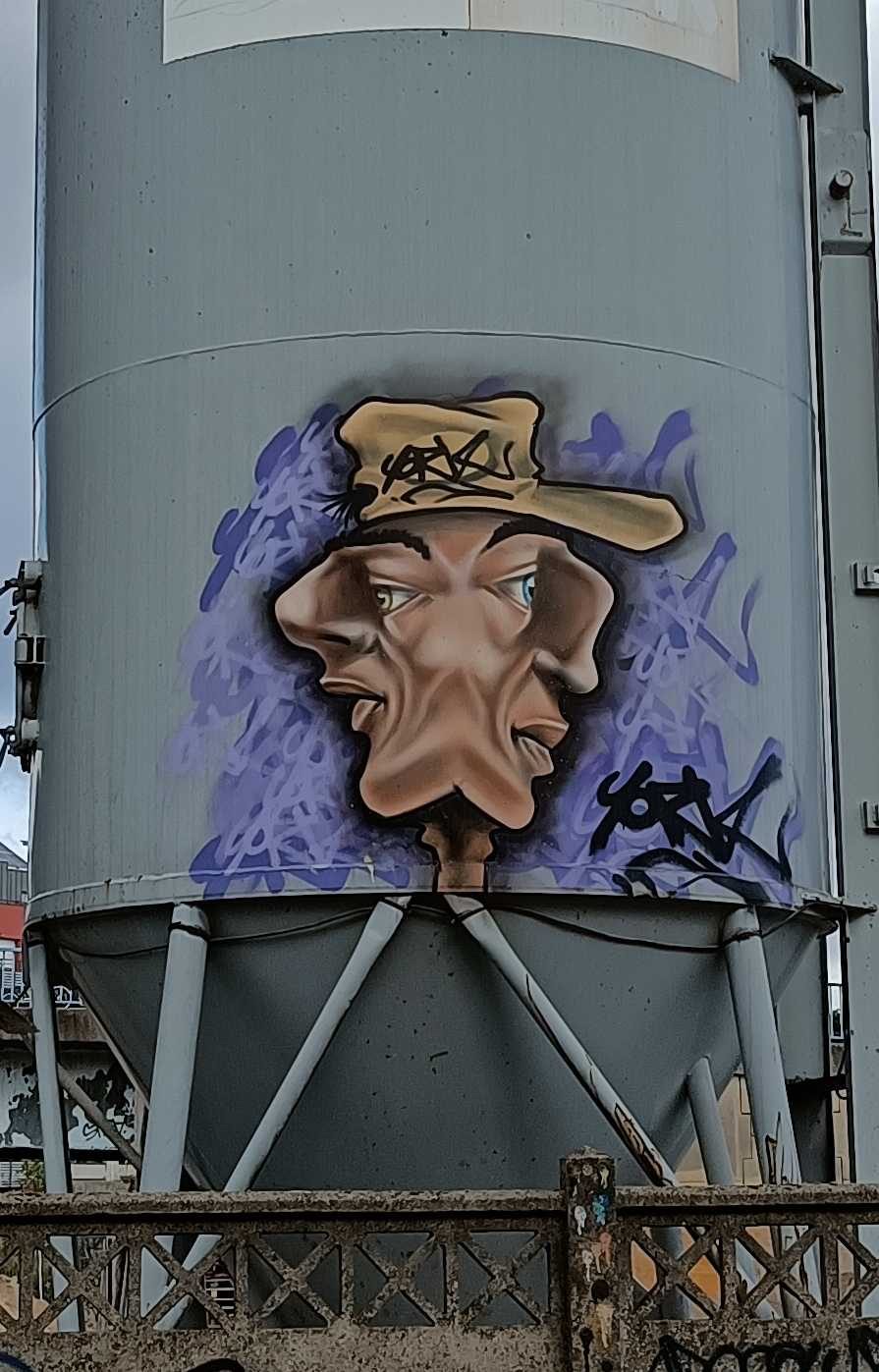 Two-Profile Head on the Silo — Street art in Saint-André-lez-Lille