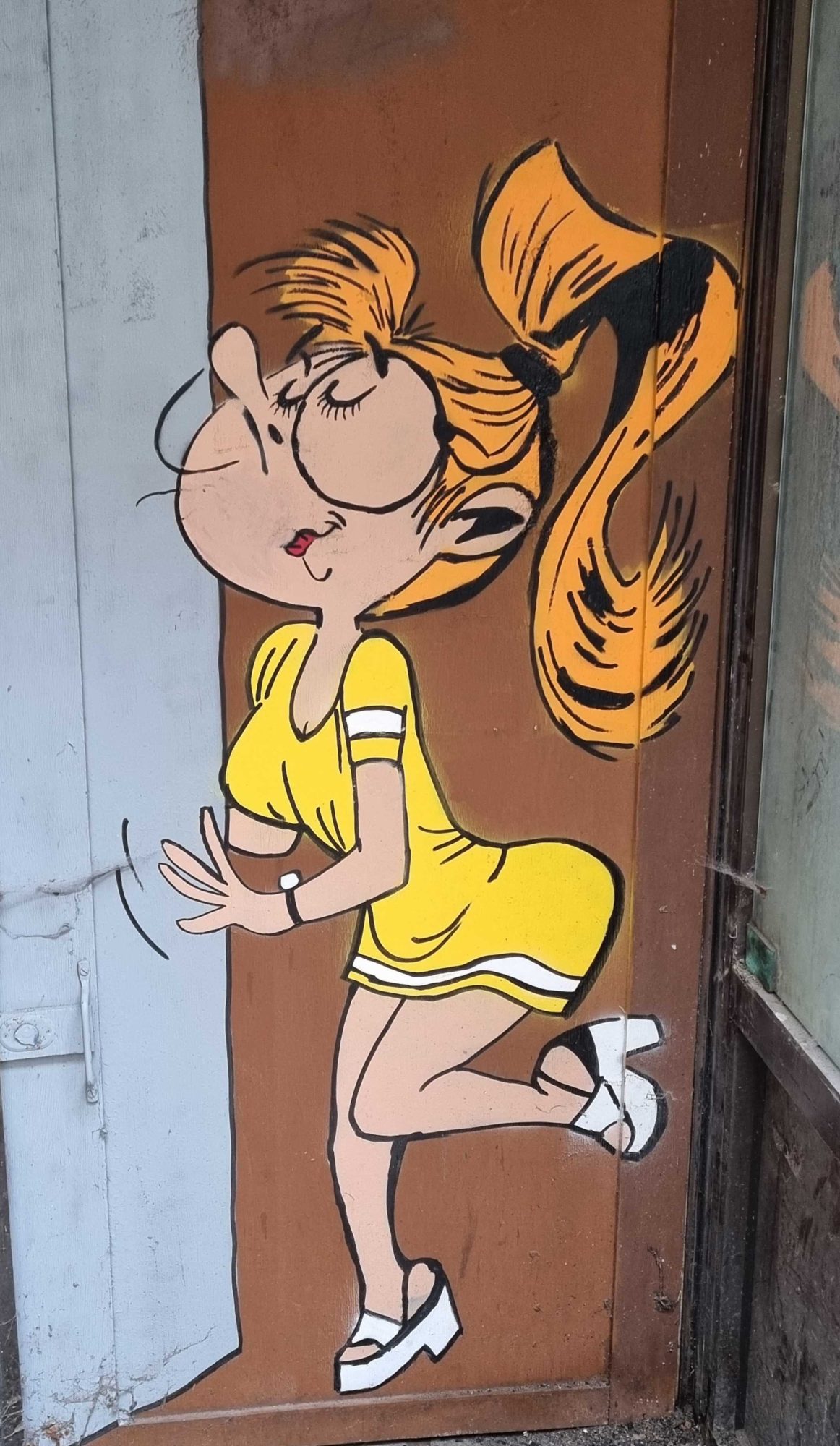 Mademoiselle Jeanne on Door — Street art in Clermont-Ferrand