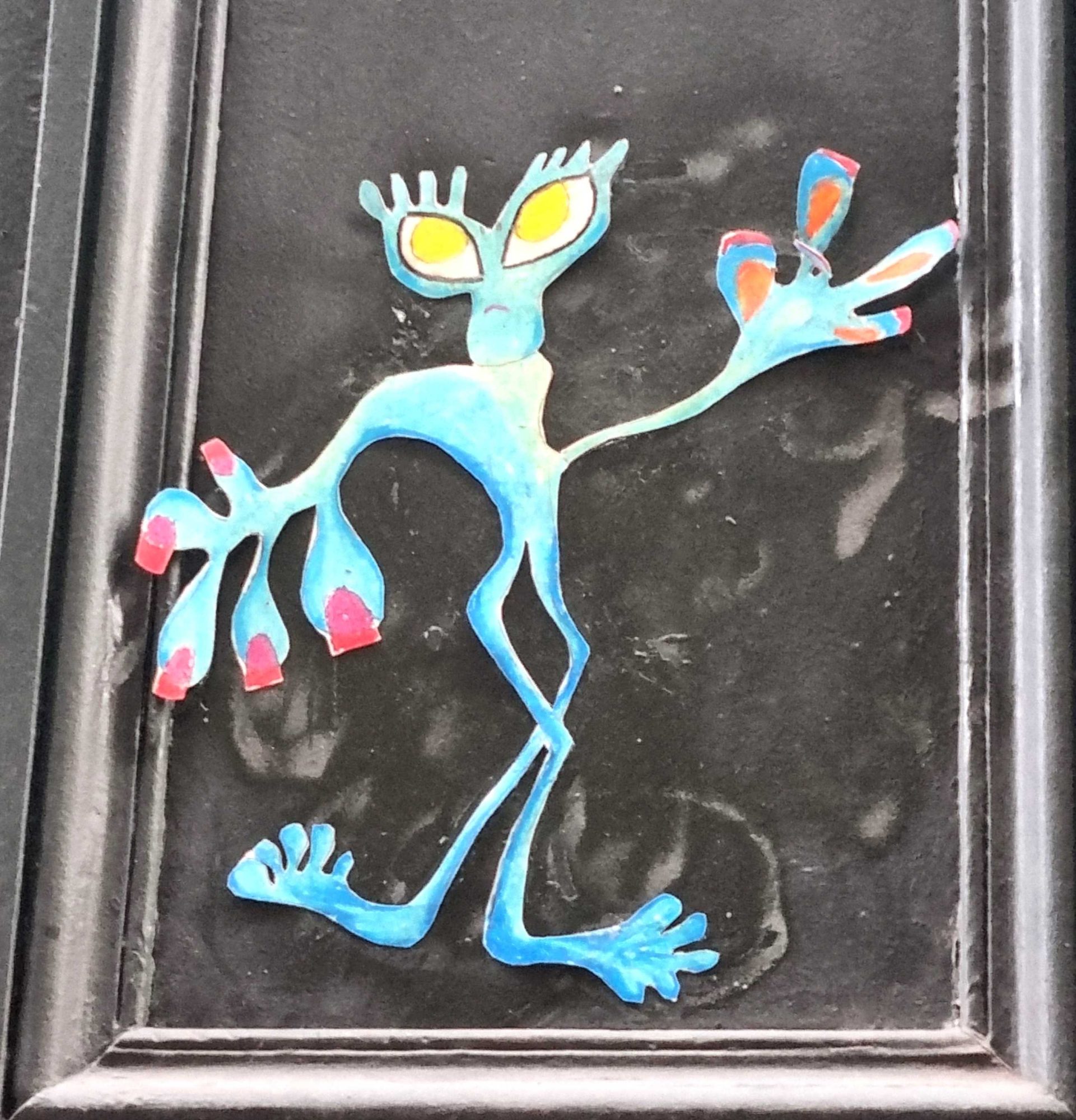 Blue Yellow-Eyed Alien - Door Collage — Street art in Clermont-Ferrand