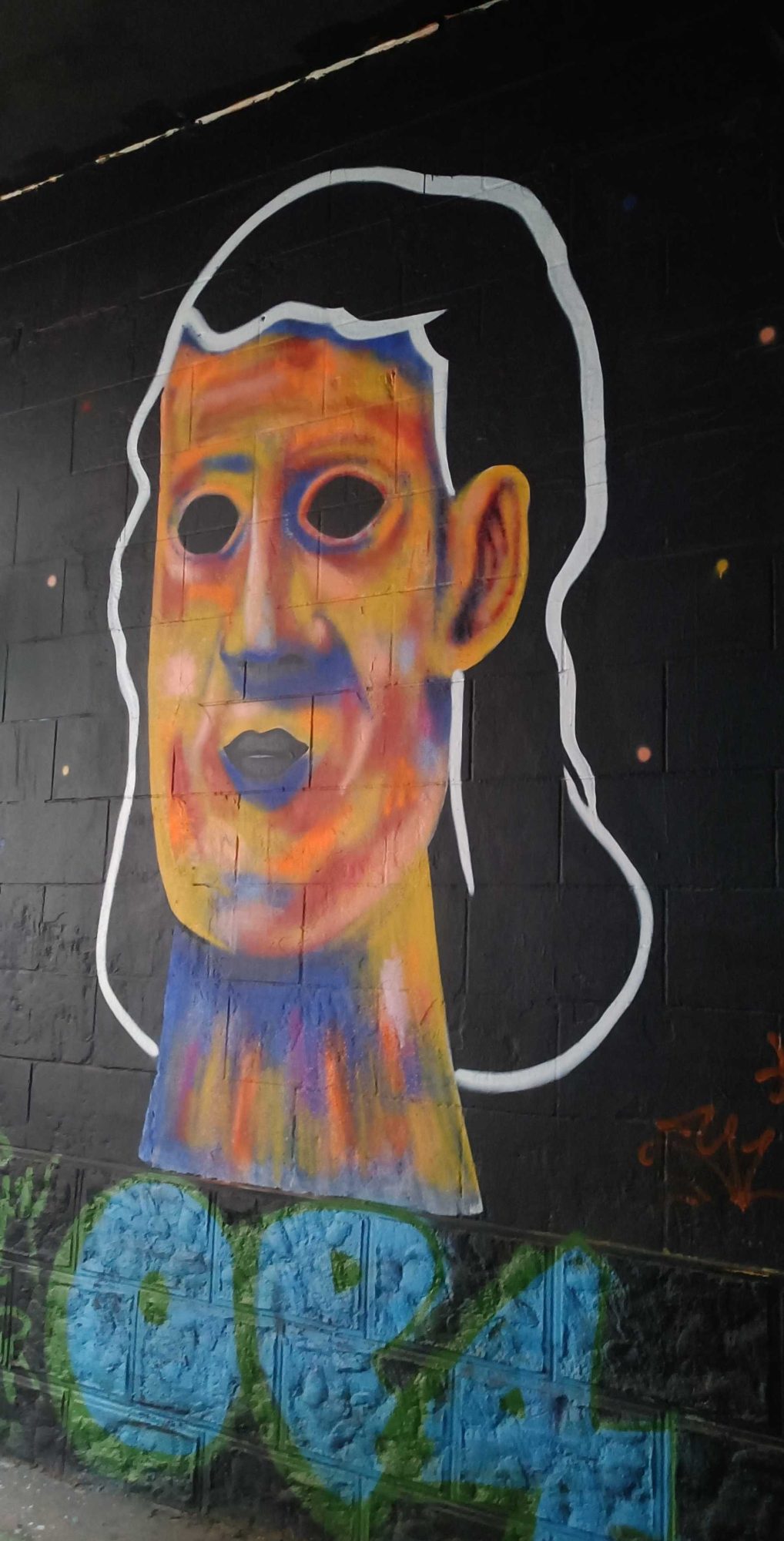Expressive Portrait with Hollow Eyes on Black Background — Street art in Nantes