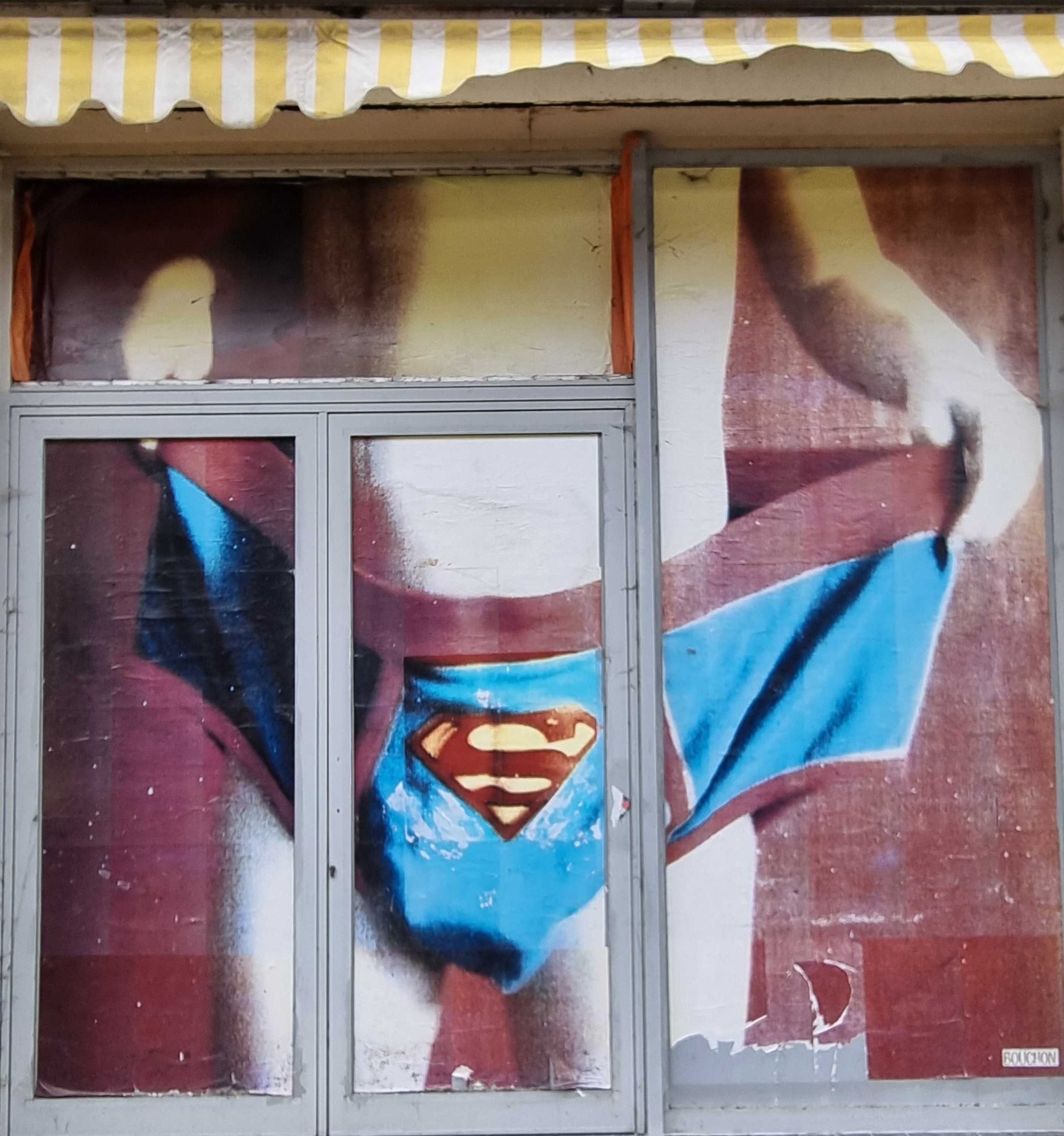 Superman Revealed in Storefront — Street art in Clermont-Ferrand