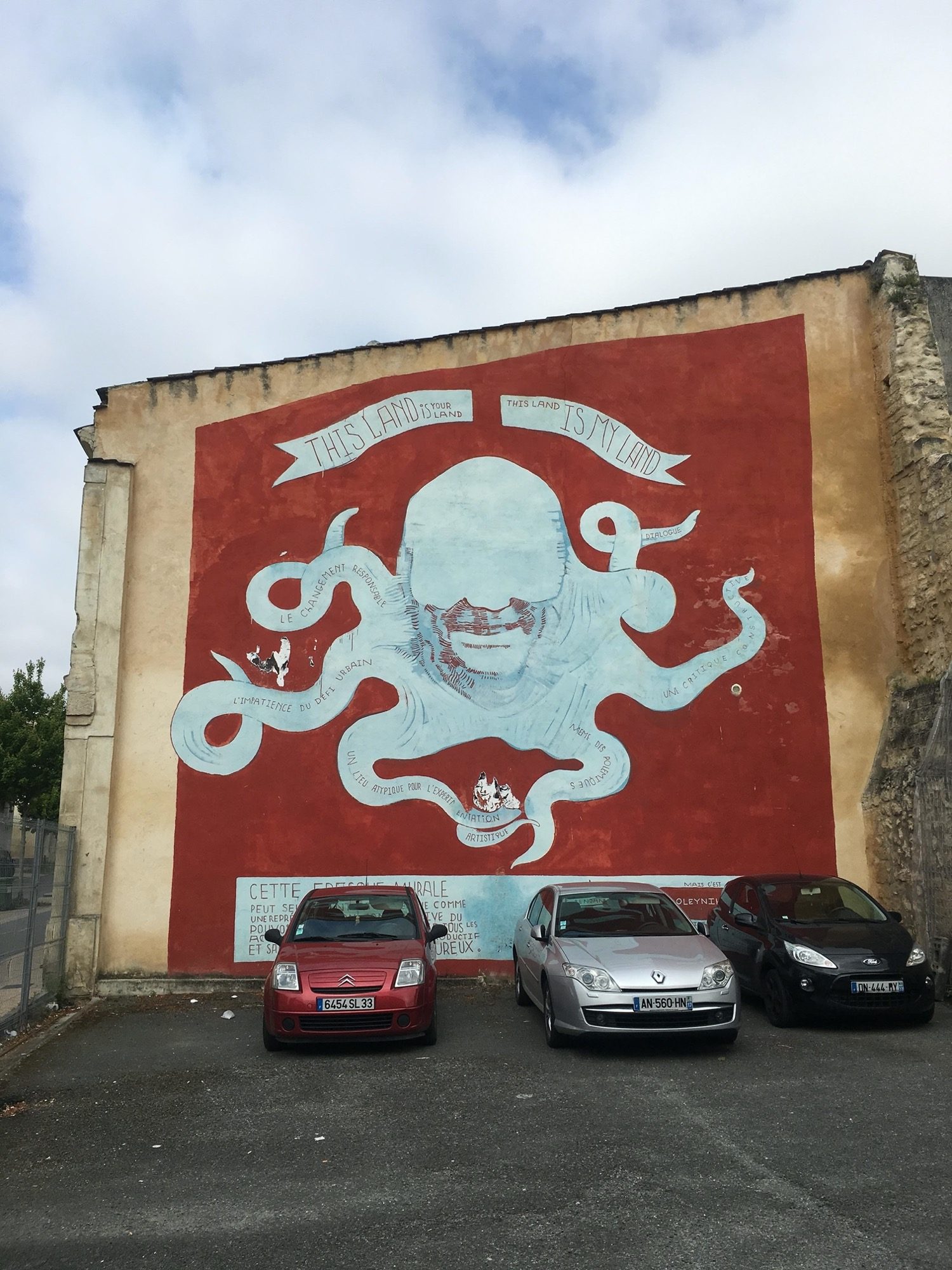 Octopus Man on Red — Street art in Bordeaux
