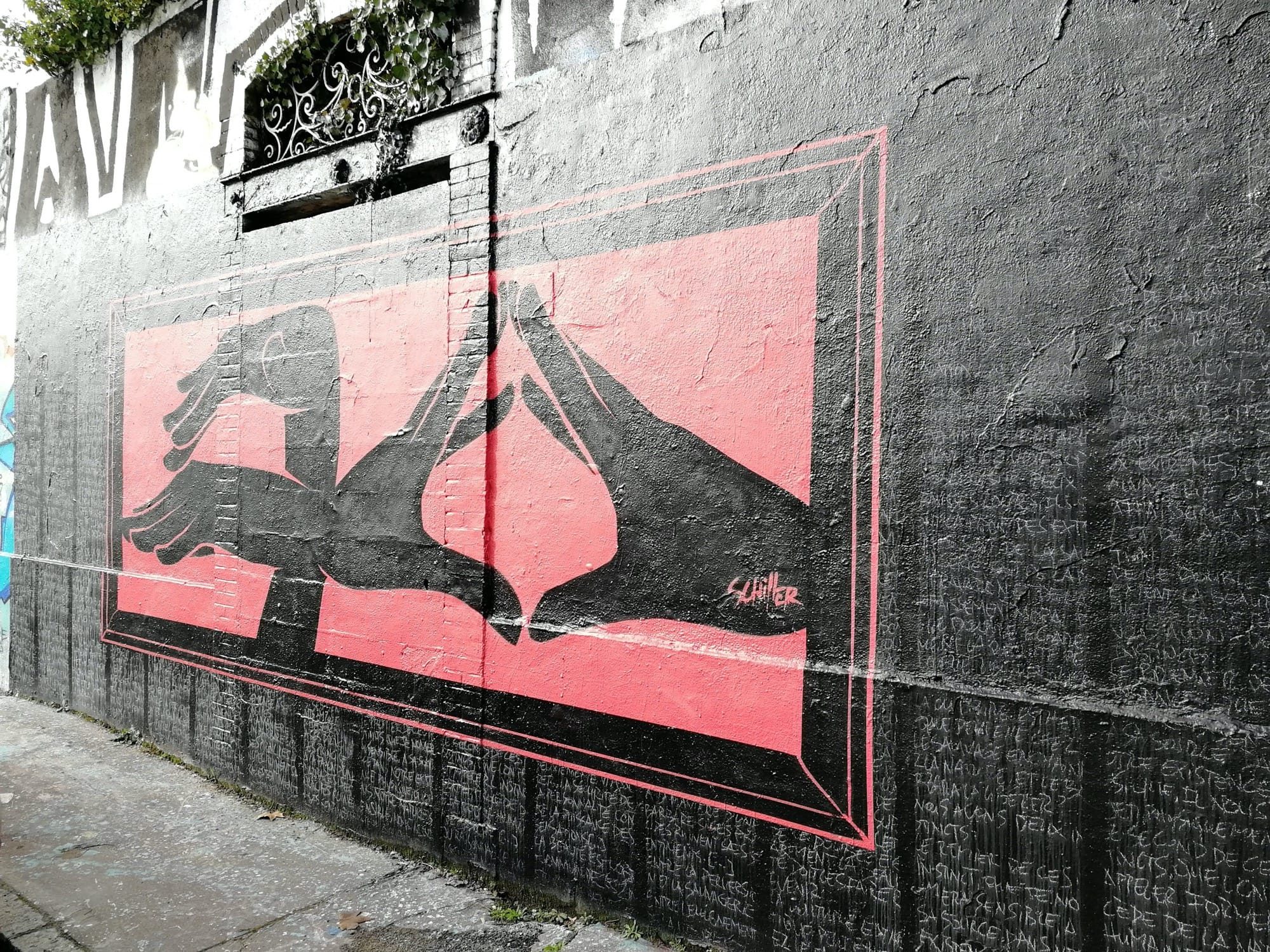 Shadow-Puppet Hands on a Pink Panel — Street art in Nantes