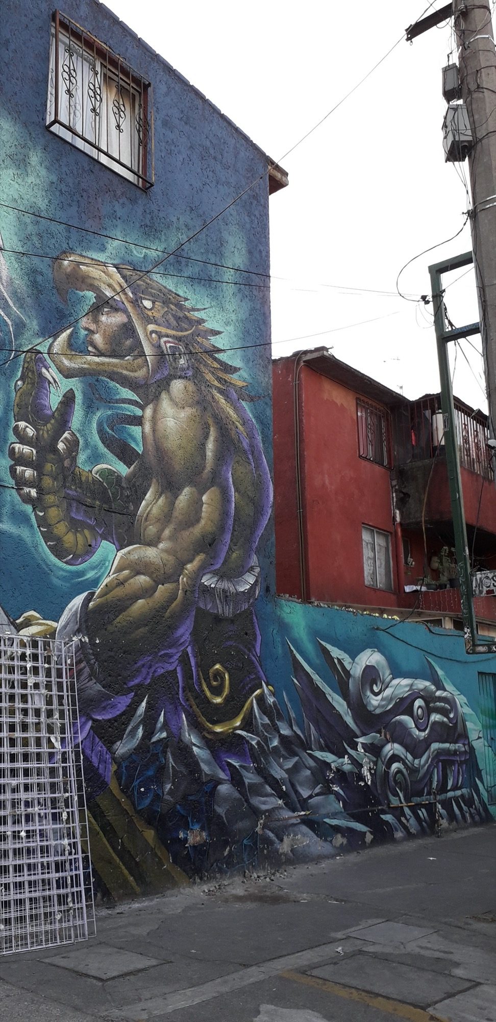 Aztec Warrior on the Building Corner — Street art in Mexico City