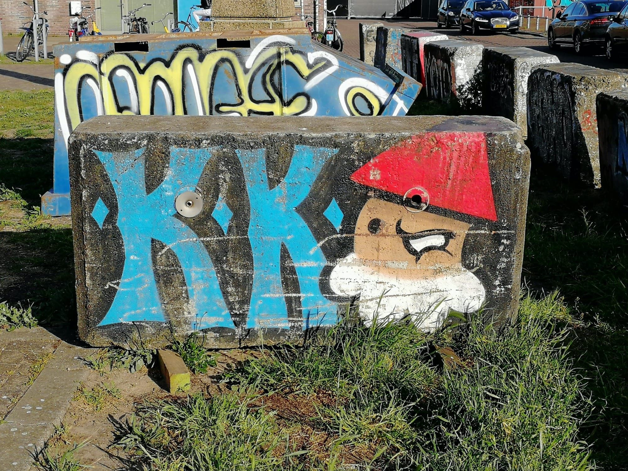 KK and Pirate on Concrete Block — Street art in Amsterdam