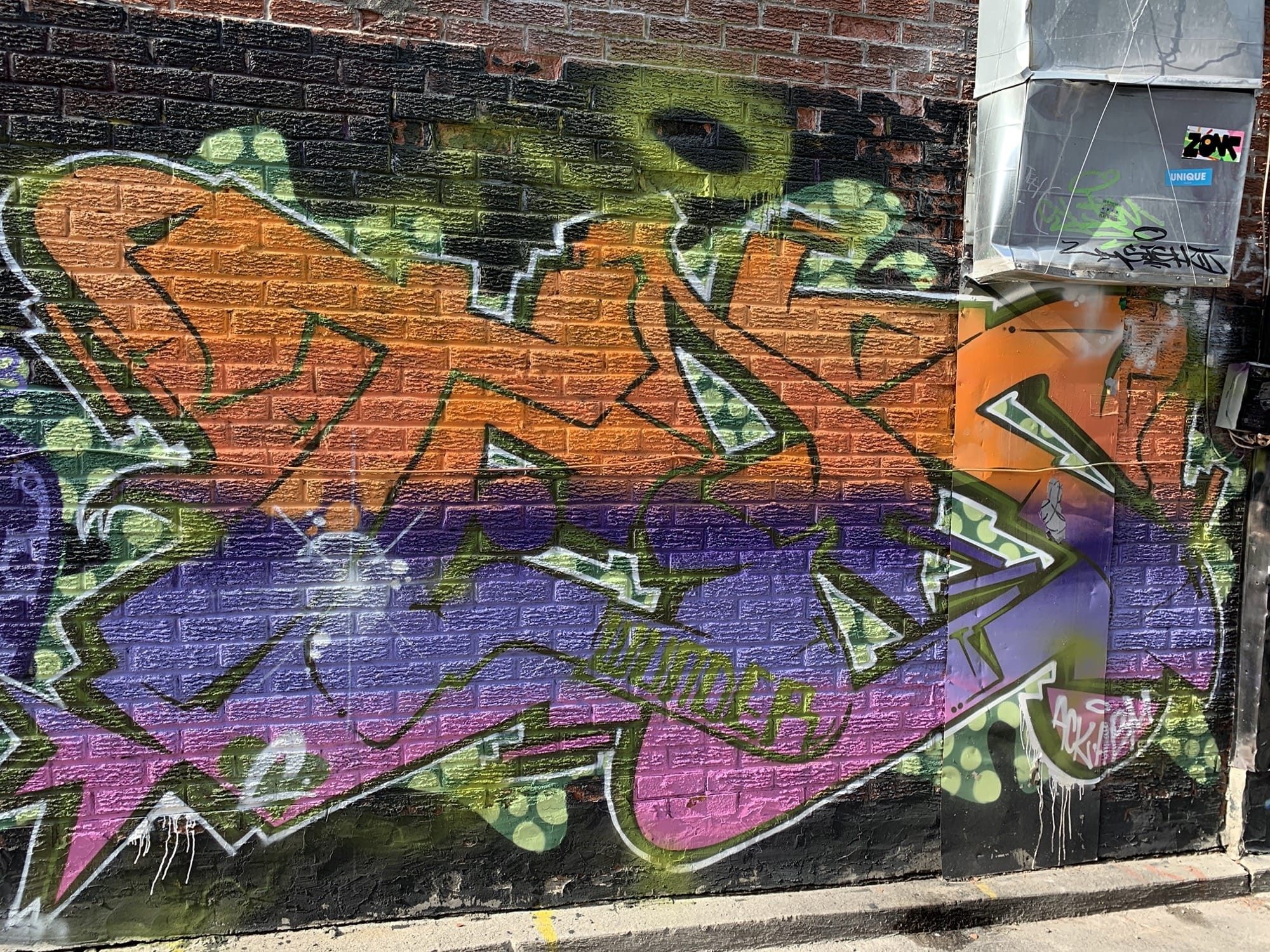 Orange and Magenta Piece Outlined in Green — Street art in Toronto