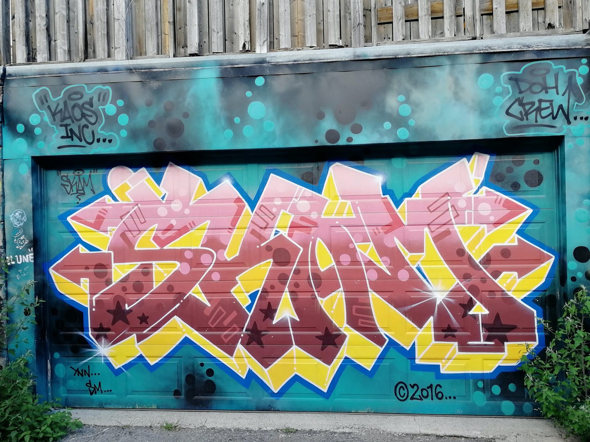 Pink Piece on a Turquoise Door, Kaos Inc — Street art in Toronto