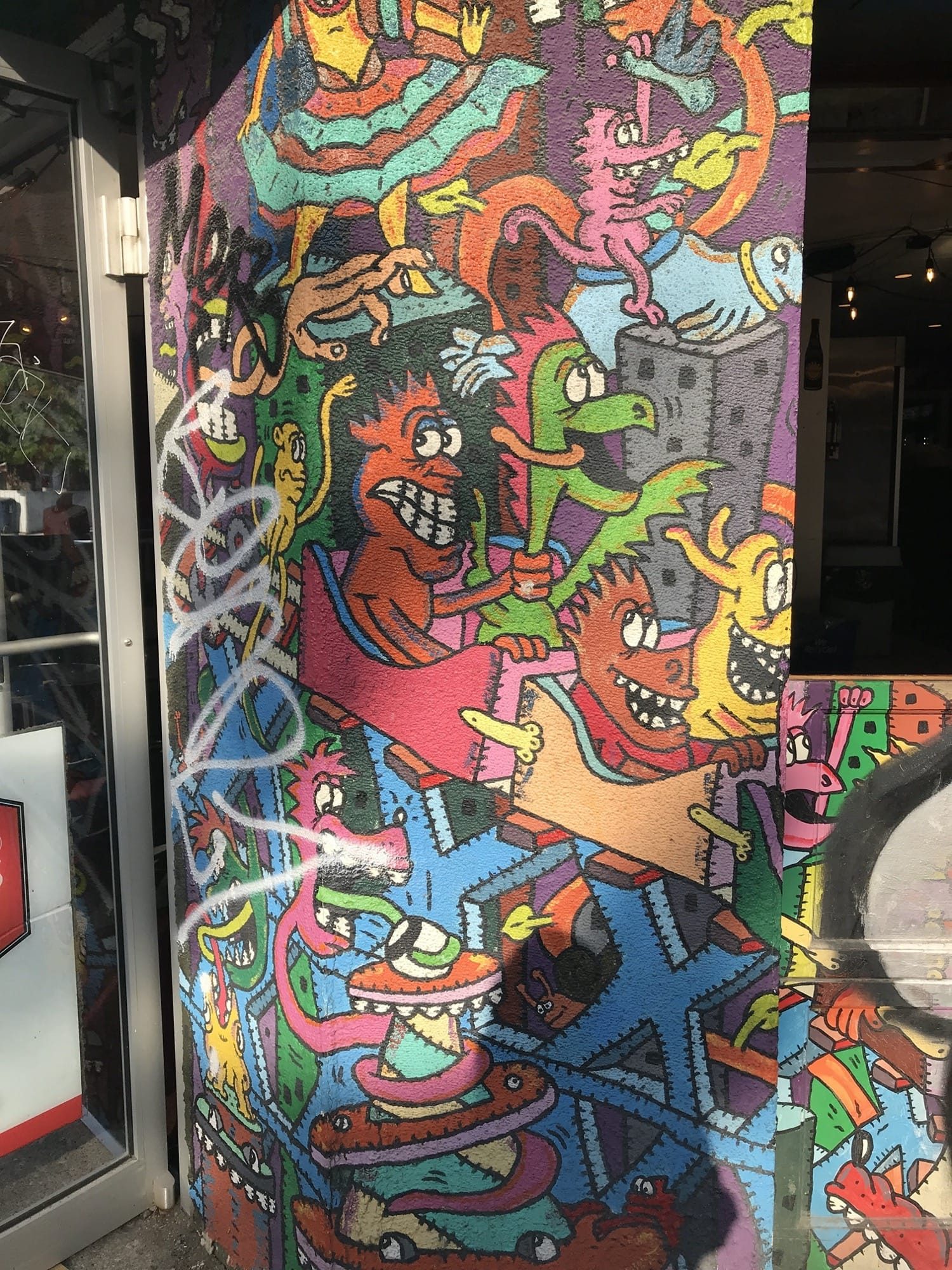 Psychedelic Creatures on Shop Door — Street art in Toronto
