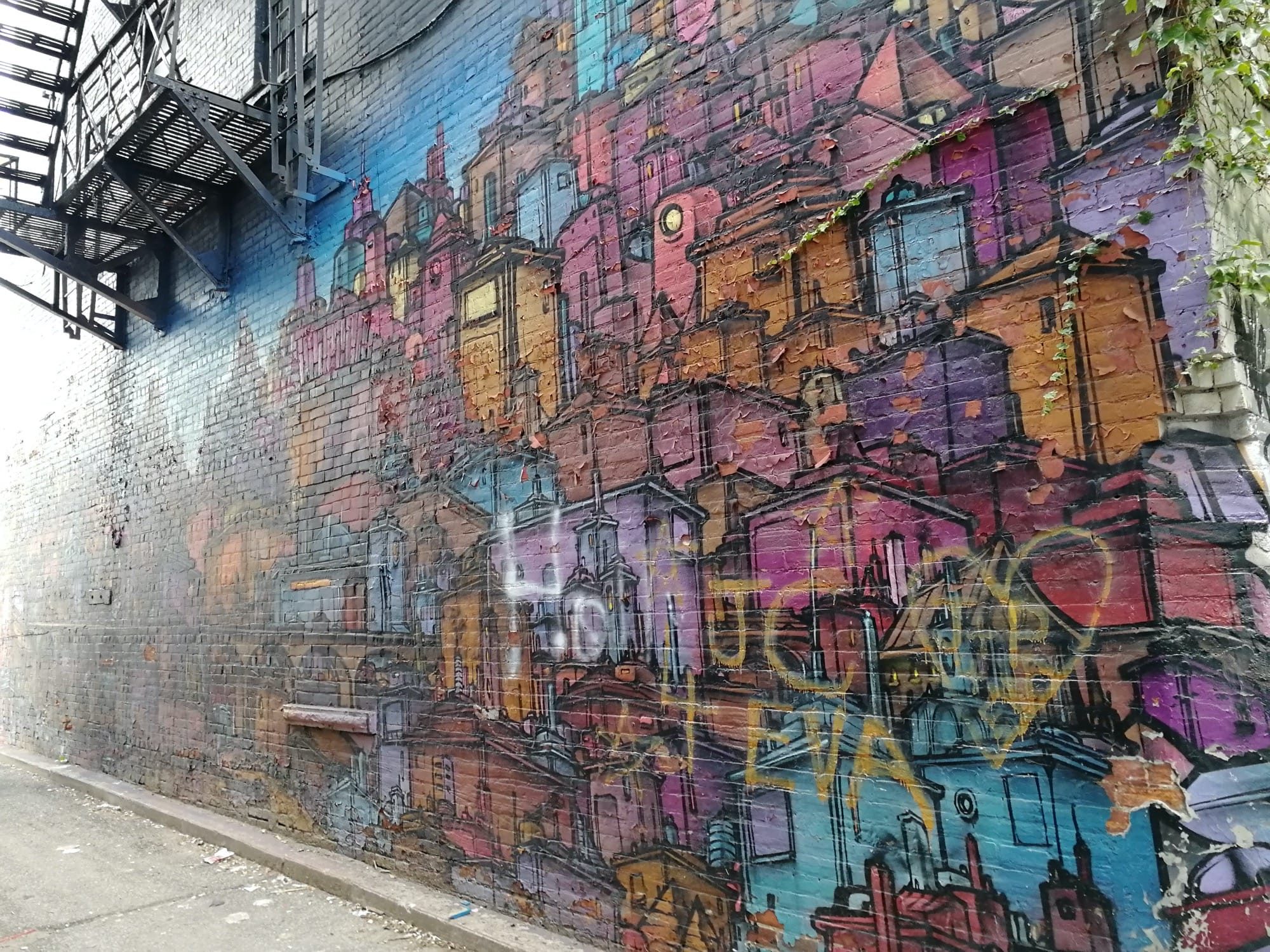 European City Panorama on Brick Wall — Street art in Toronto