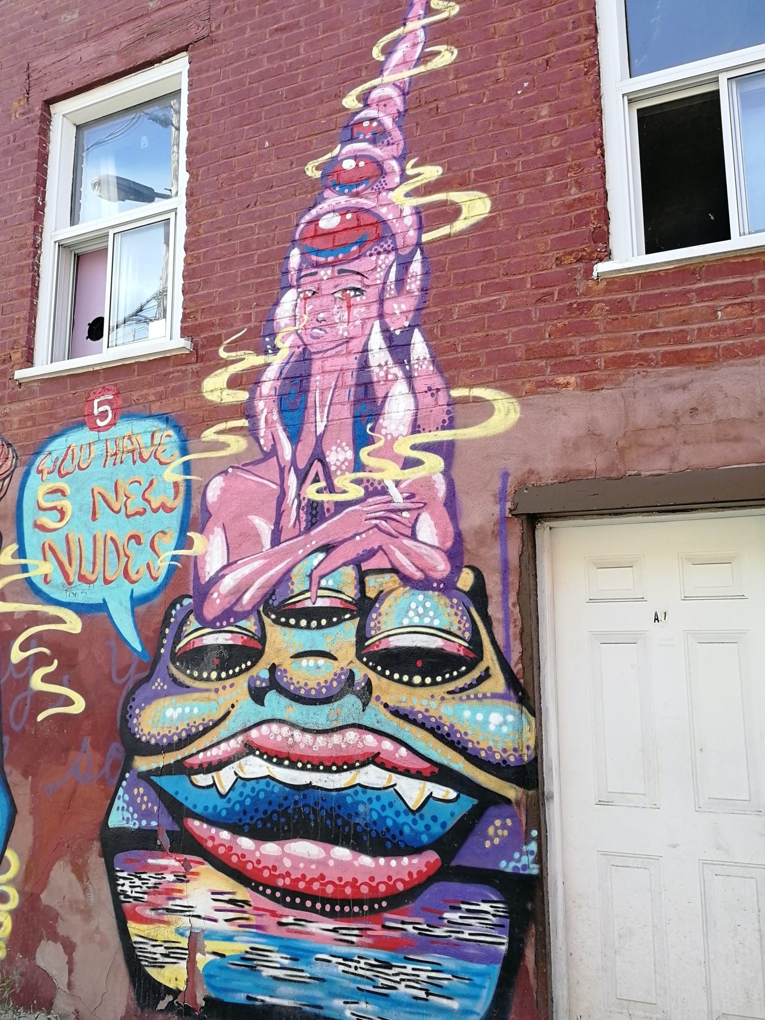 The Totem of Stacked Faces — Street art in Montréal
