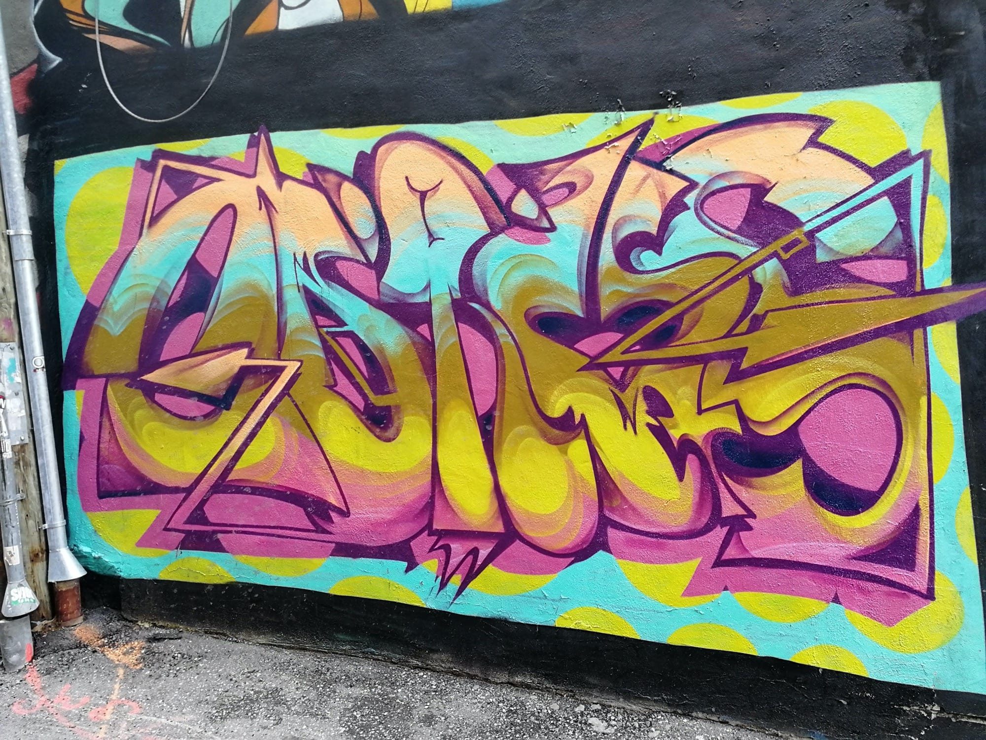 Pink and Yellow Lettering with a Lightning Bolt — Street art in Montréal