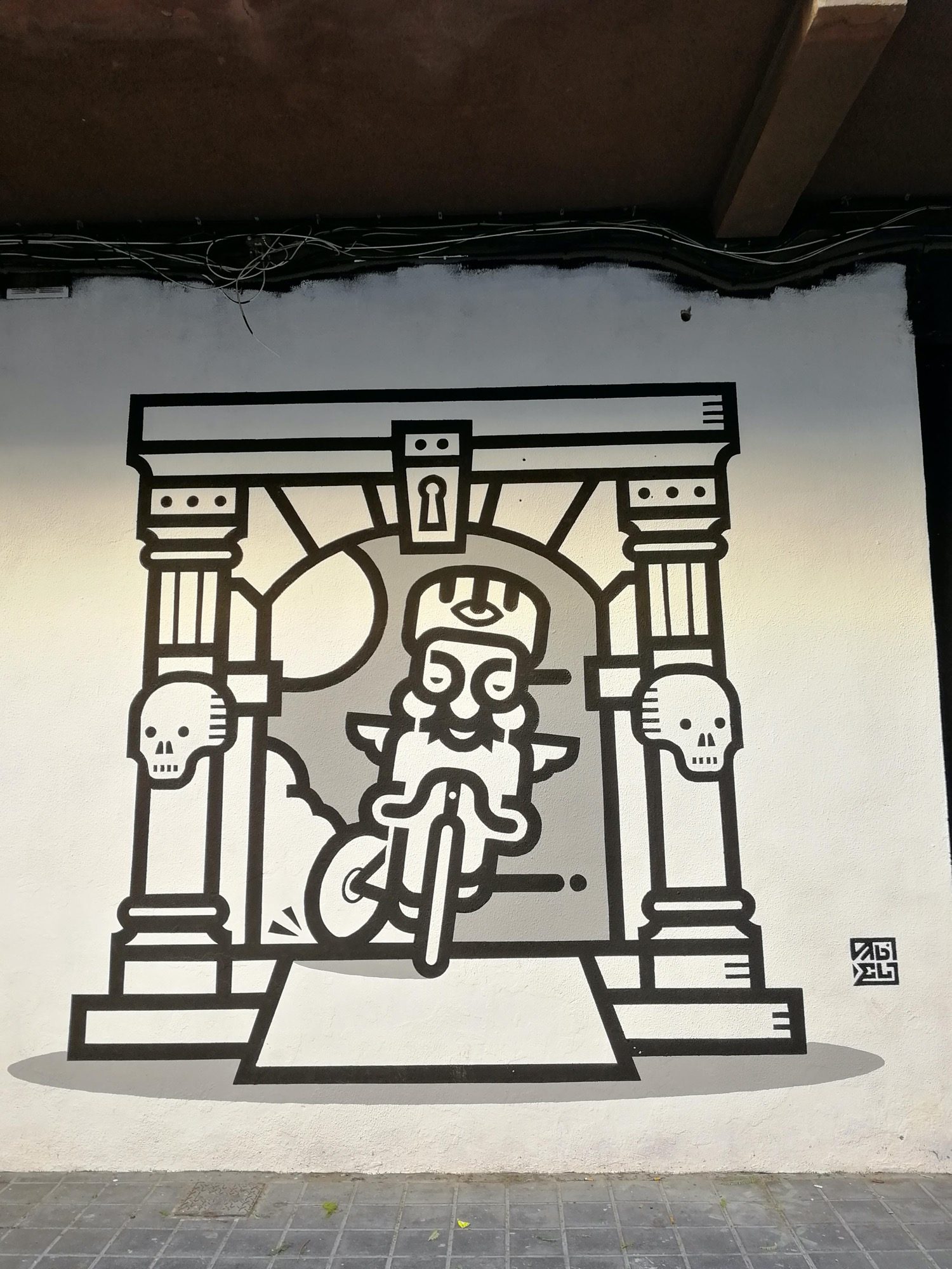Cyclist Under Arch with Skulls - Black and White — Street art in València