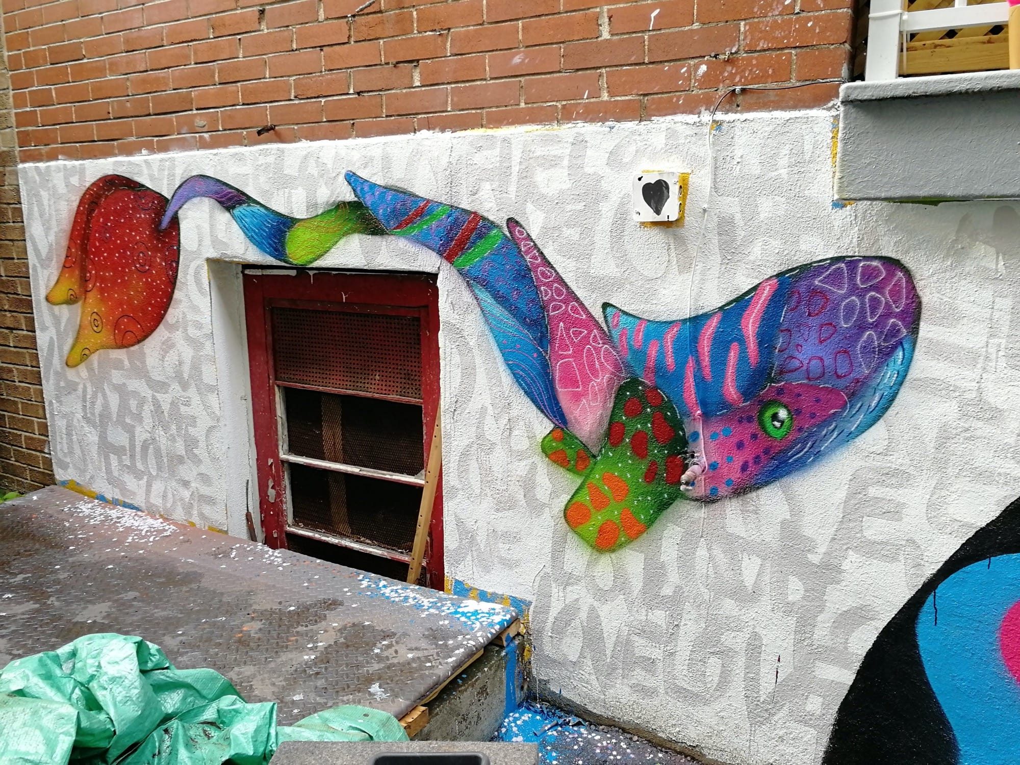Blue Fish at the Basement Window — Street art in Montréal