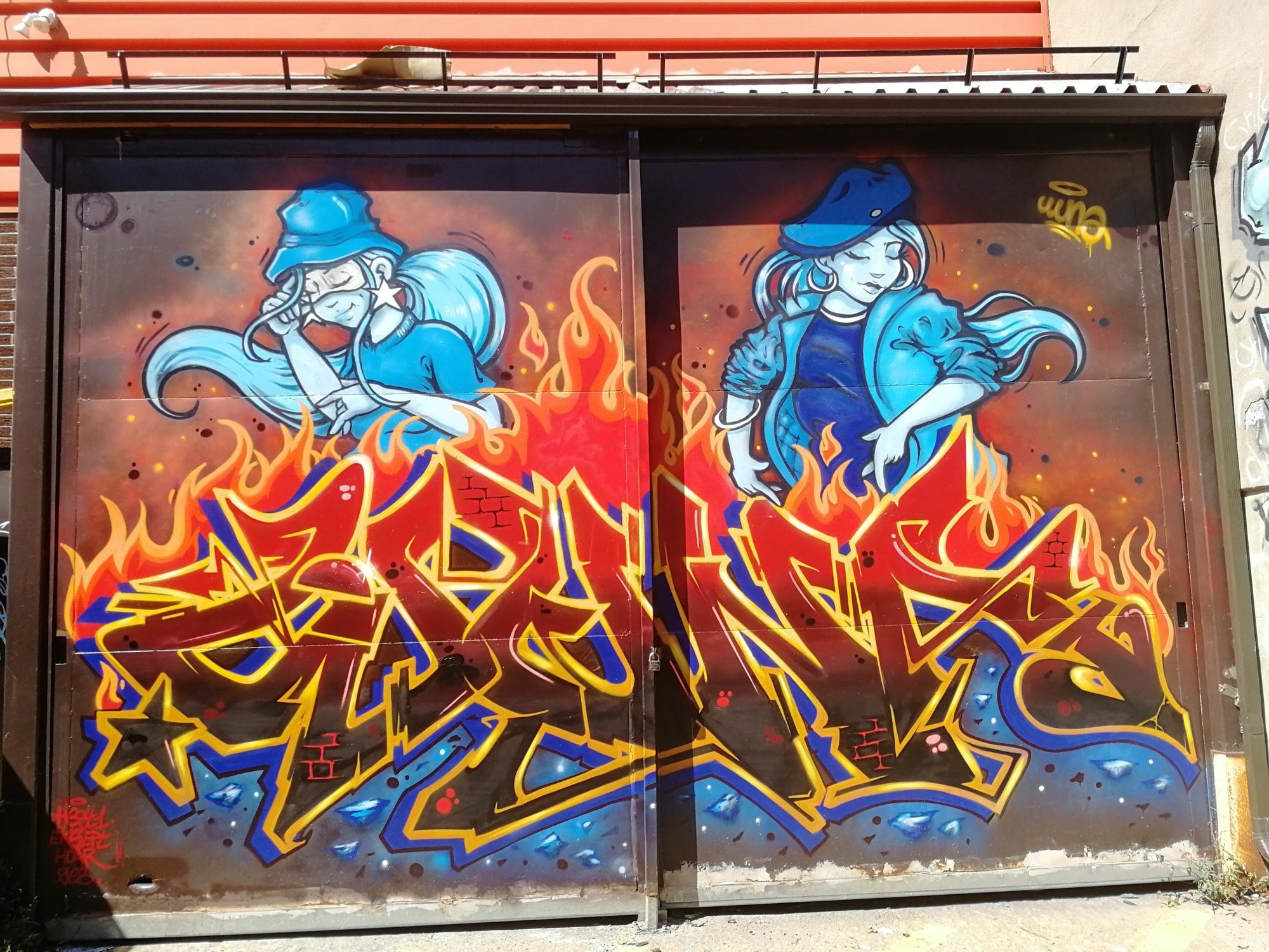 Blue Characters Above the Flames — Street art in Montréal