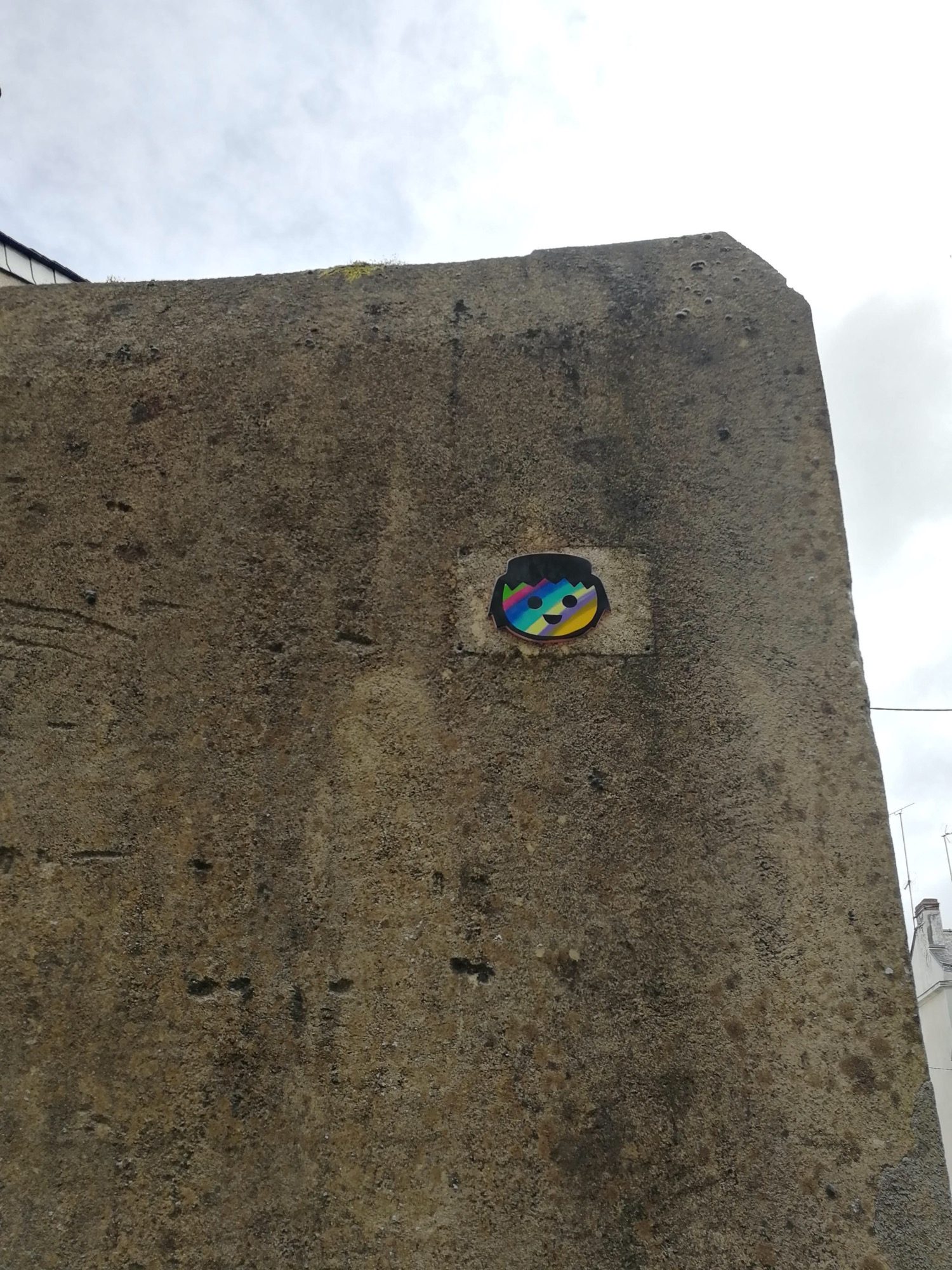 Rainbow Head on the Gable — Street art by Fast Freak in Angers