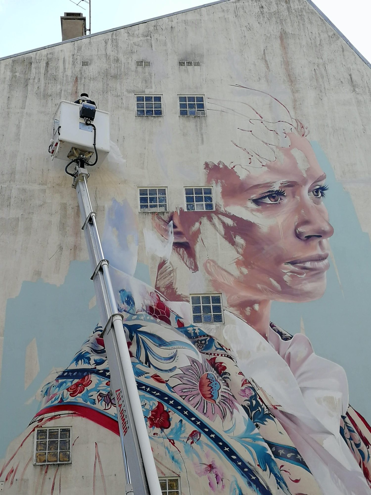 The Woman in the Embroidered Jacket — Street art by Hopare in Saint-Brieuc