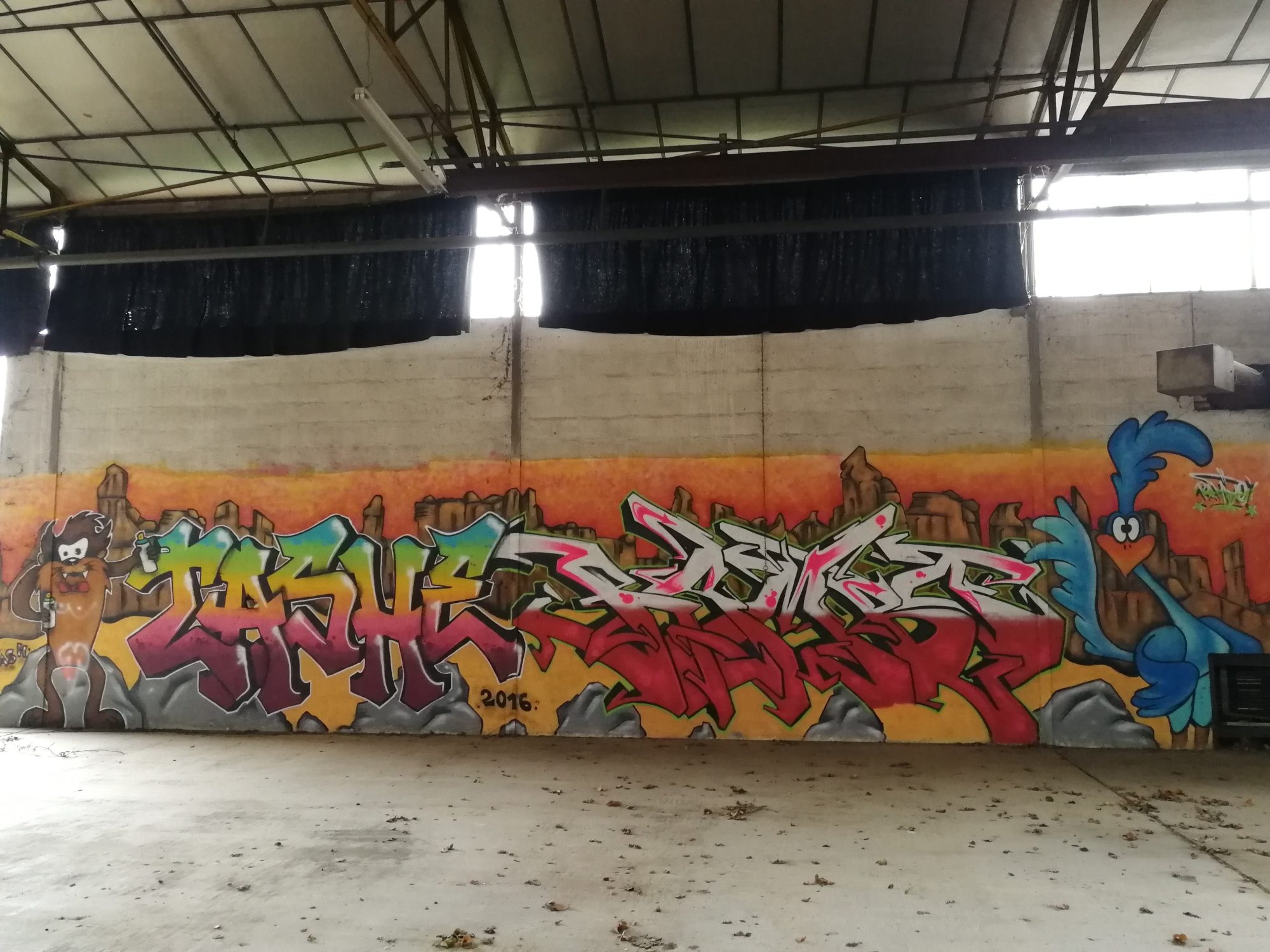 Cartoons and Lettering on an Orange Sky — Street art in Issé