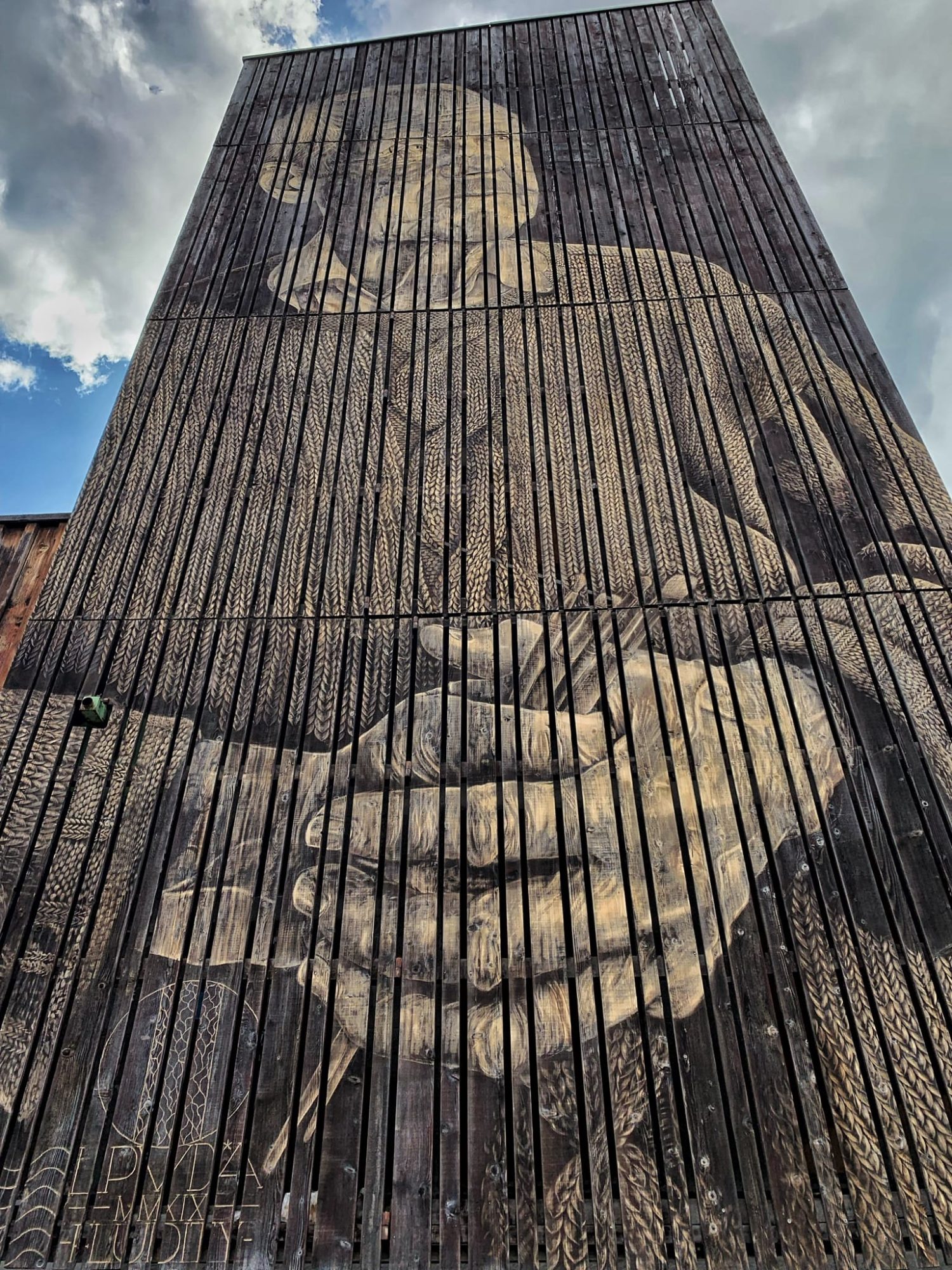 The old man with clasped hands — Street art by LPVDA in Leysin