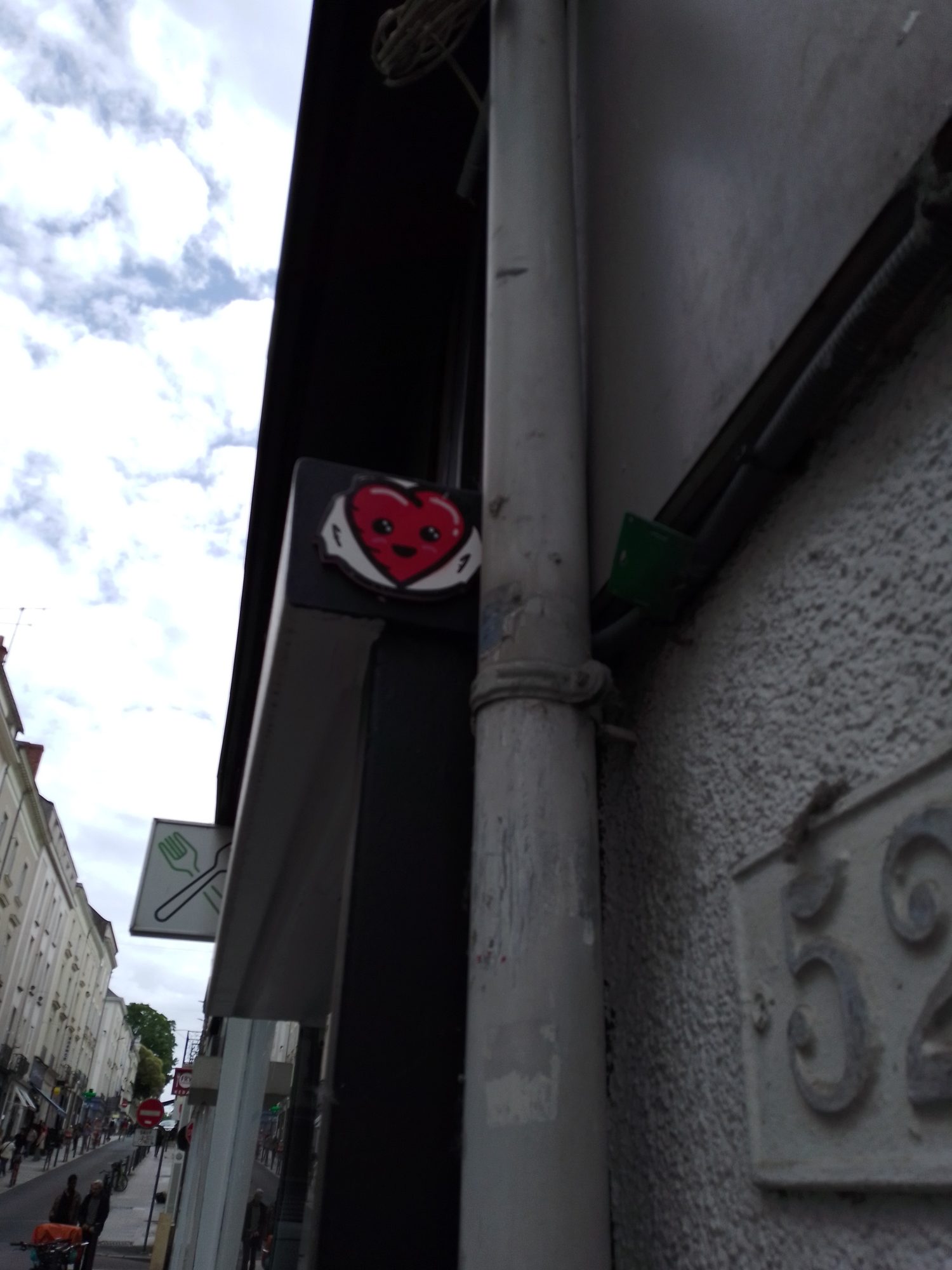The Smiling Heart above the Awning — Street art by Fast Freak in Angers