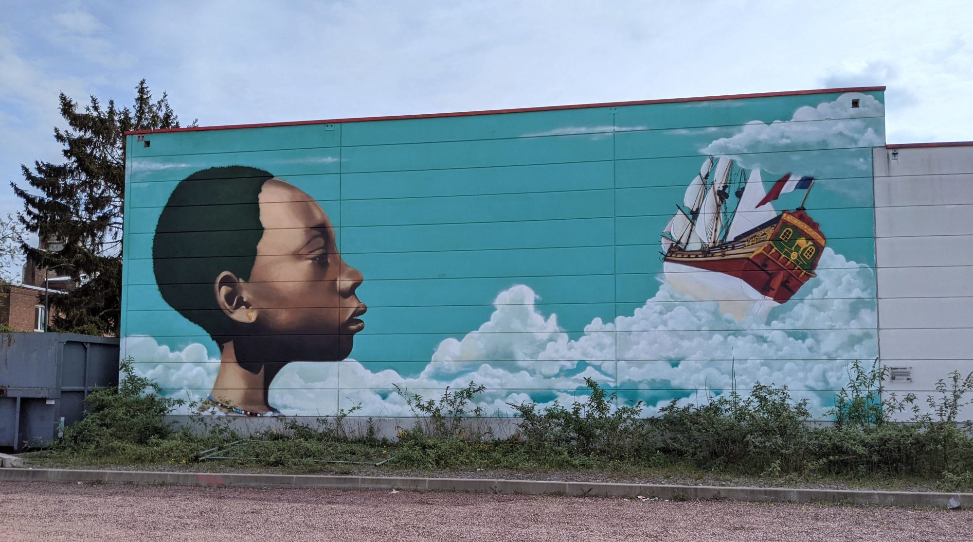 Child Gazing at a Sailing Ship in the Clouds — Street art in Roubaix