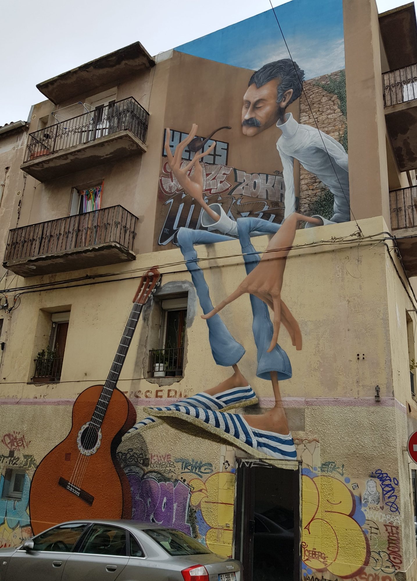 The Man with Enormous Legs and the Guitar — Street art by Mayé in Sète