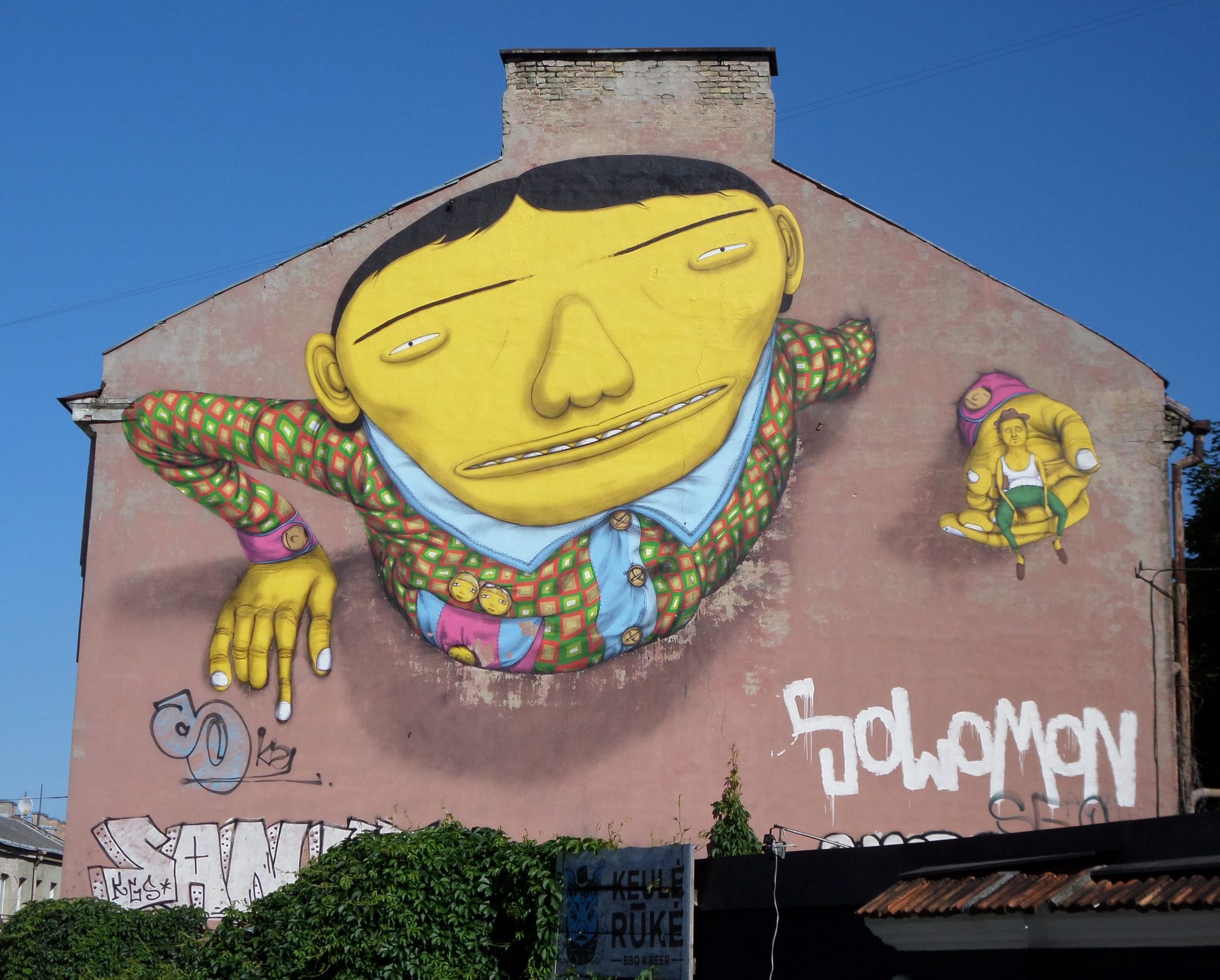 Smiling Yellow Giant — Street art by Osgemeos in Vilnius