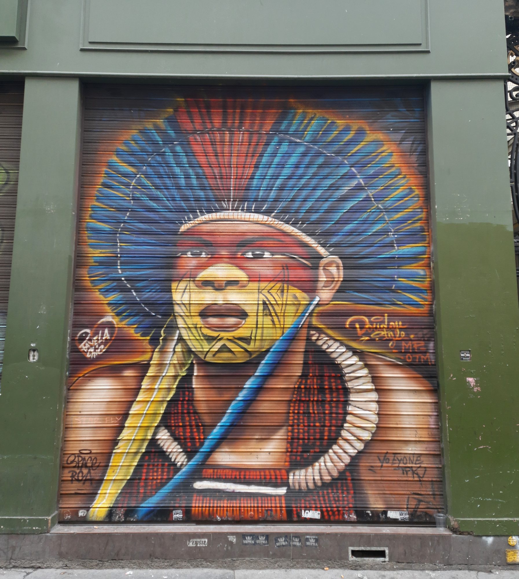 The Amazonian Chief on the Green Shutter — Street art by Doudou style in Paris