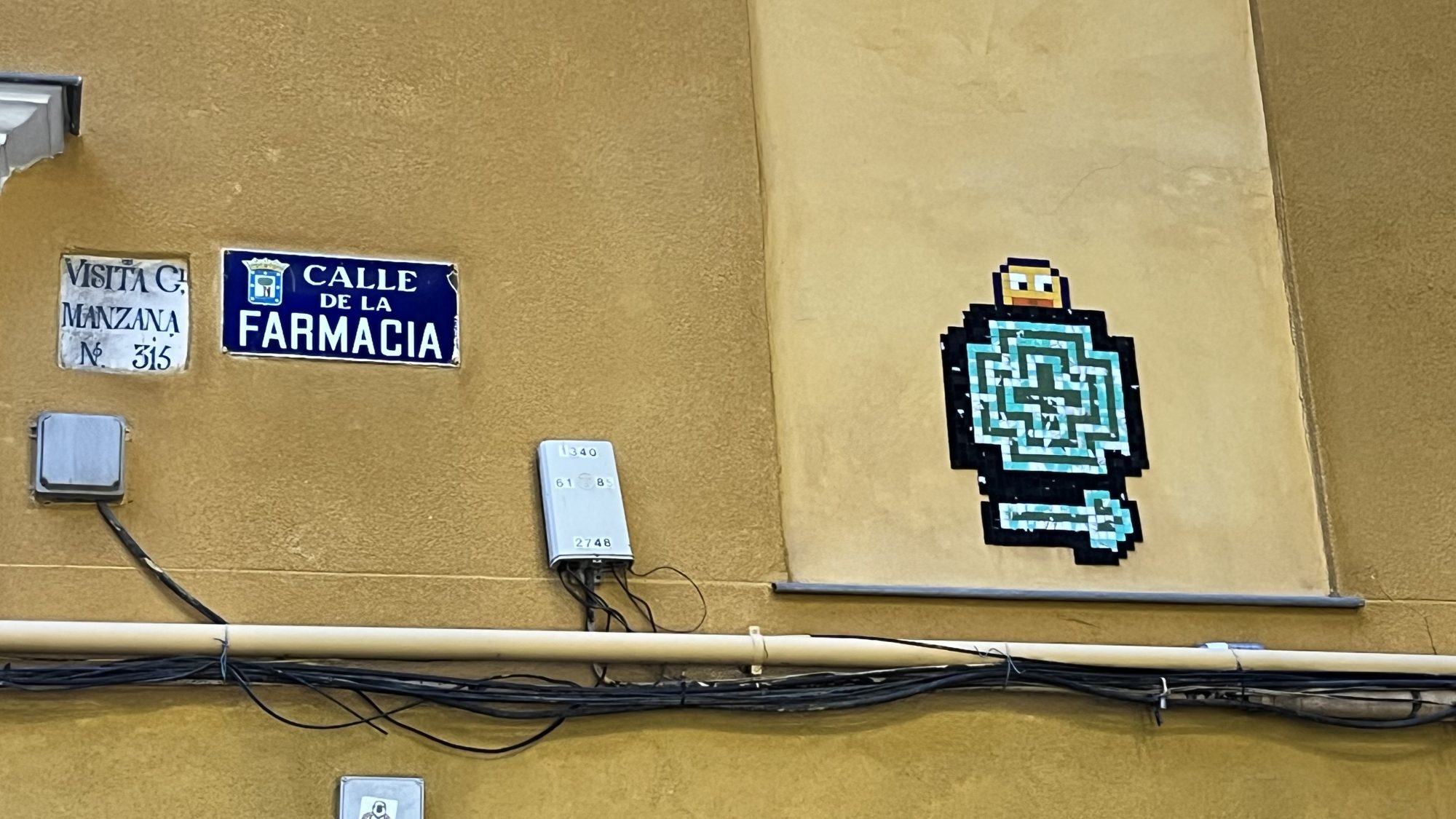 Turquoise Maze on Calle de la Farmacia — Street art in Madrid