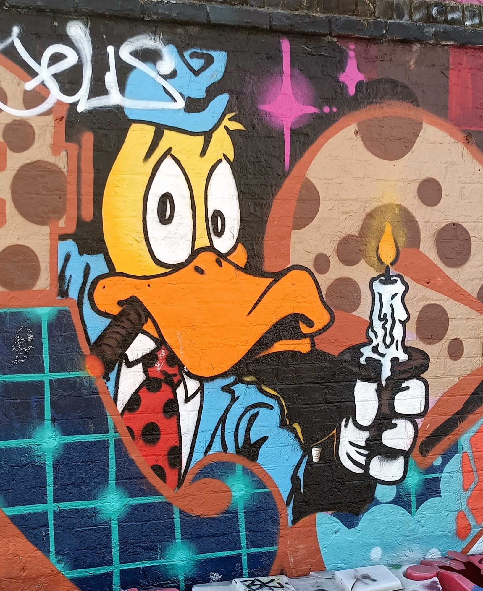 Expressive Yellow Cartoon Duck with Candle — Street art in London