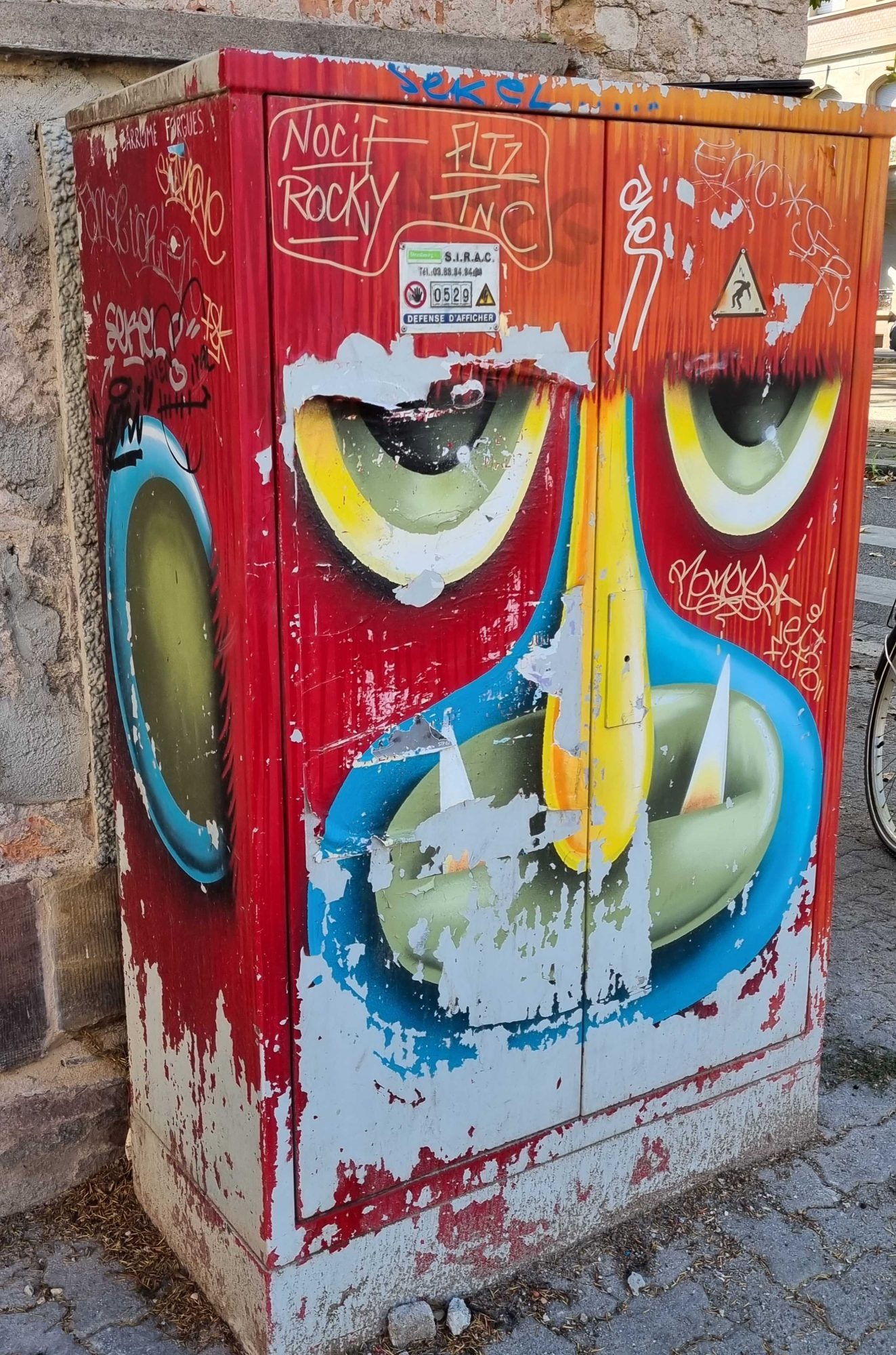 Large Red Face with Blue Fangs — Street art in Strasbourg