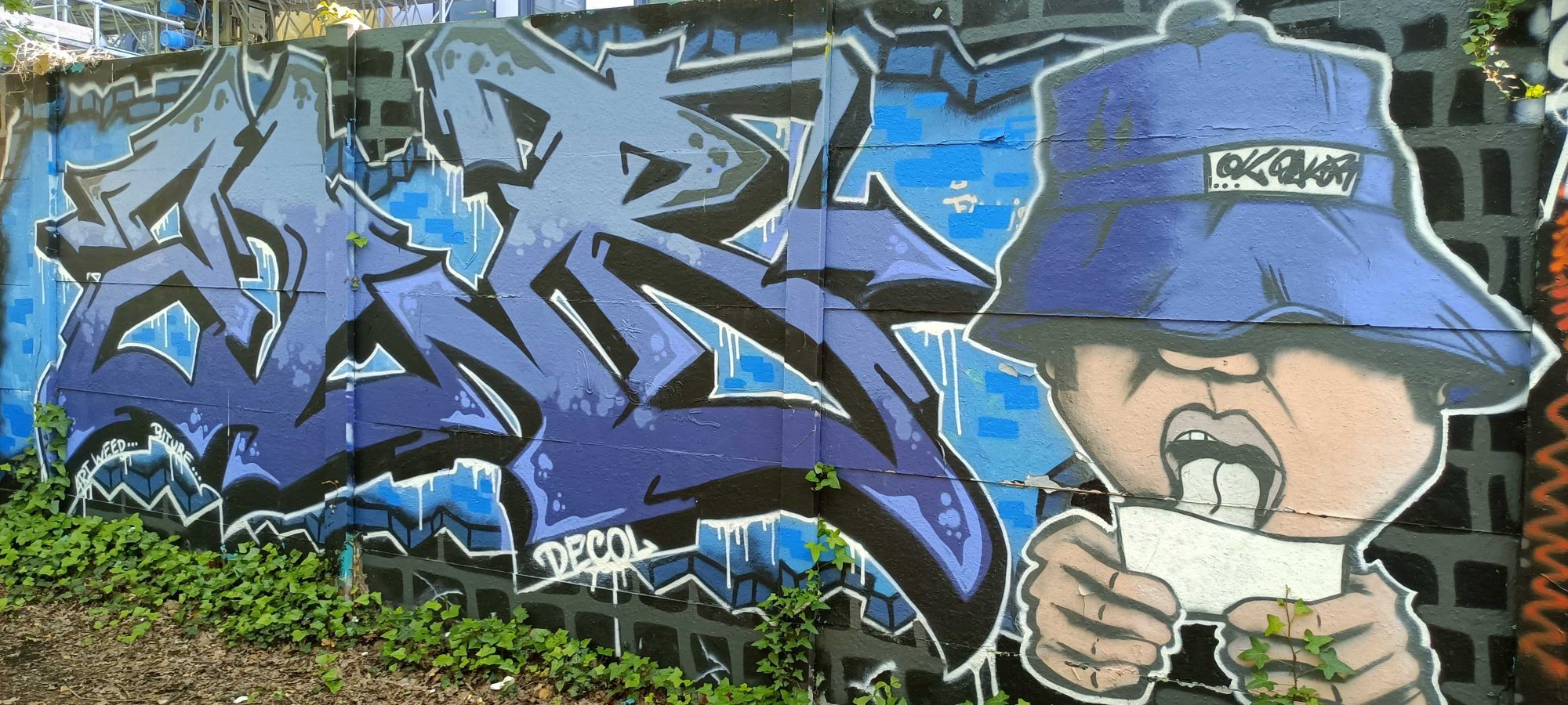 Blue Lettering and the Character in a Bucket Hat — Street art in Nantes