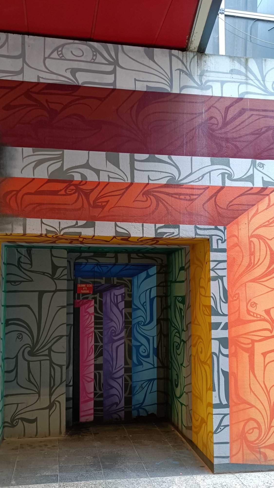 Colorful Entrance with Swirling Patterns — Street art in Paris