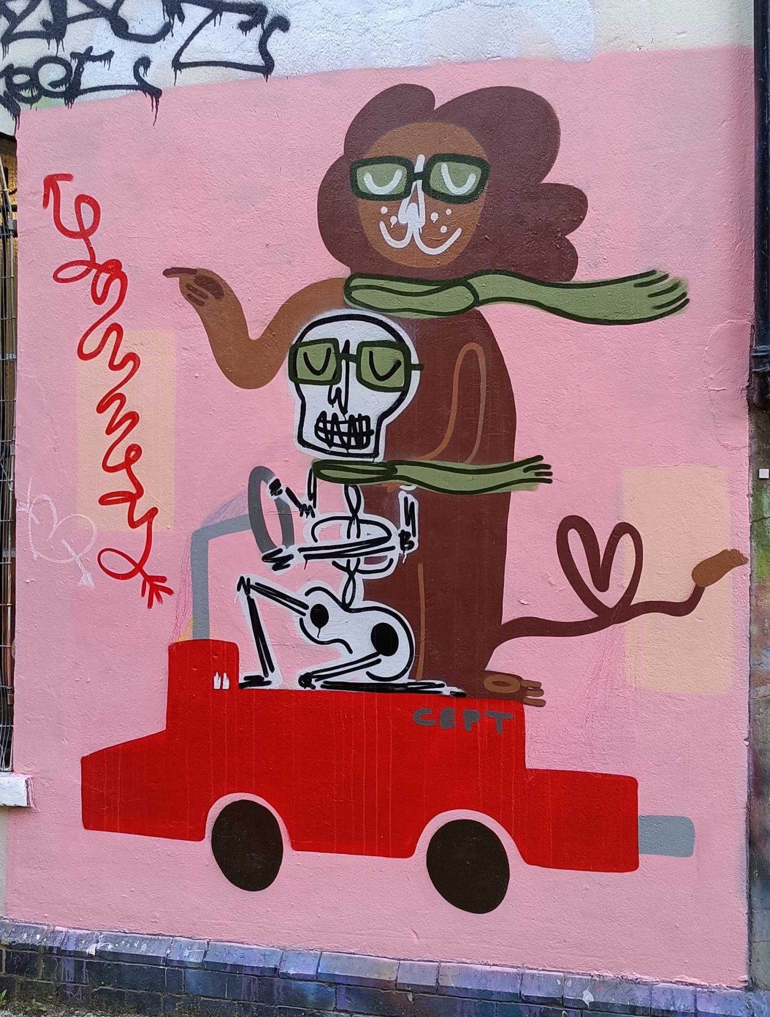 Skeleton at the wheel of the red car — Street art in London