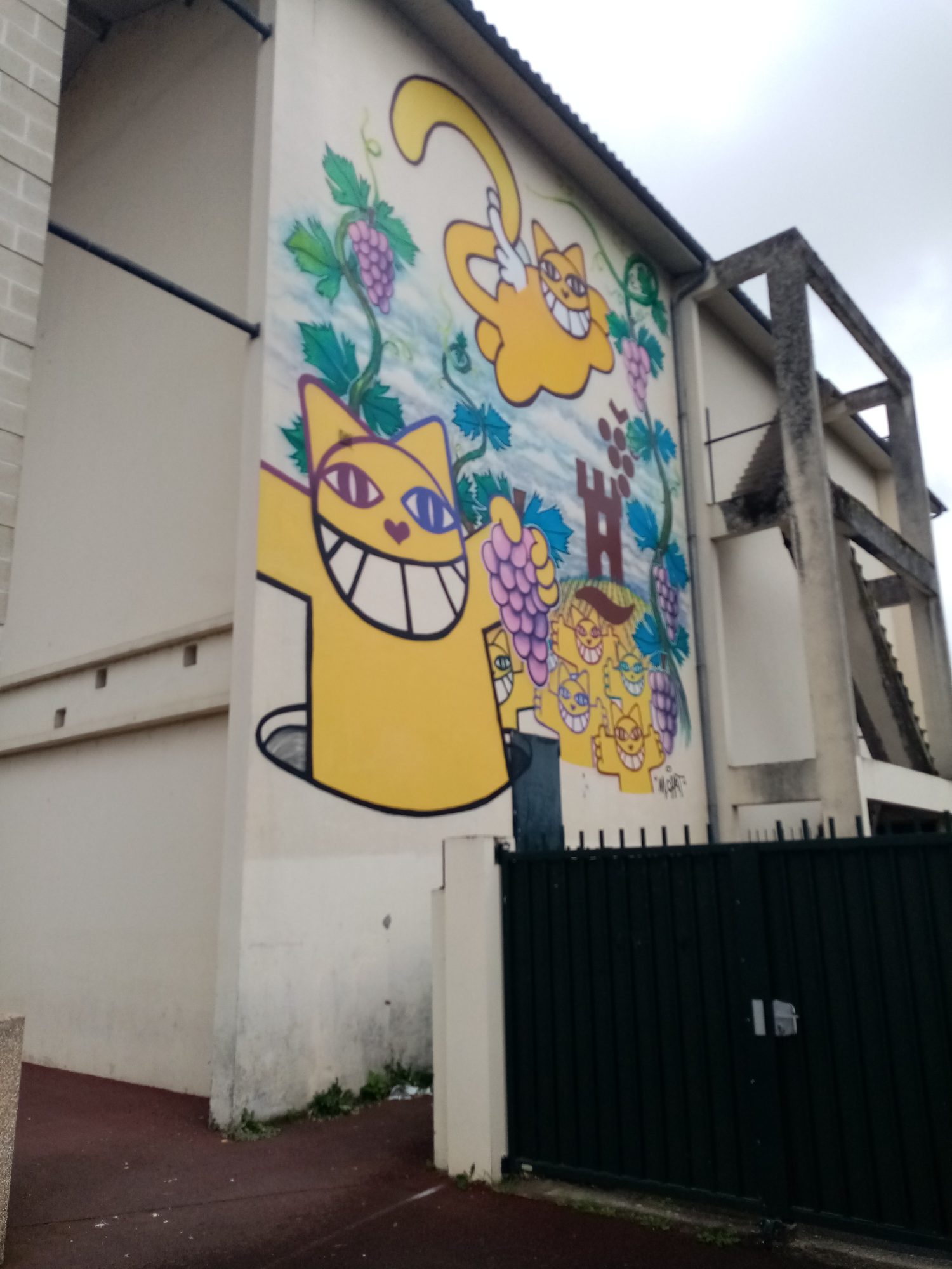Yellow Cats and Purple Grapes — Street art by M. Chat in Castillon-la-Bataille