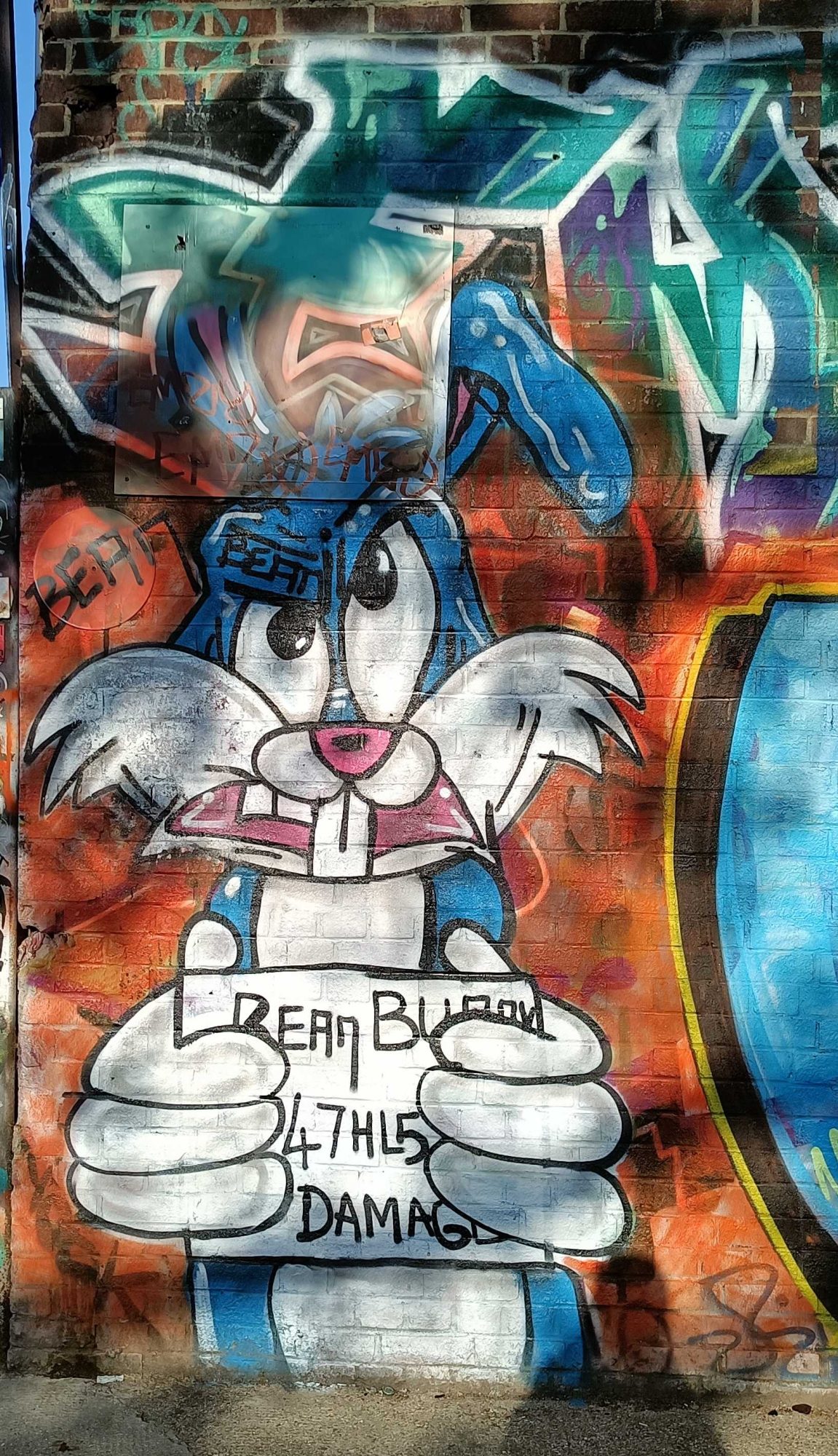 Blue and white cartoon rabbit — Street art in London