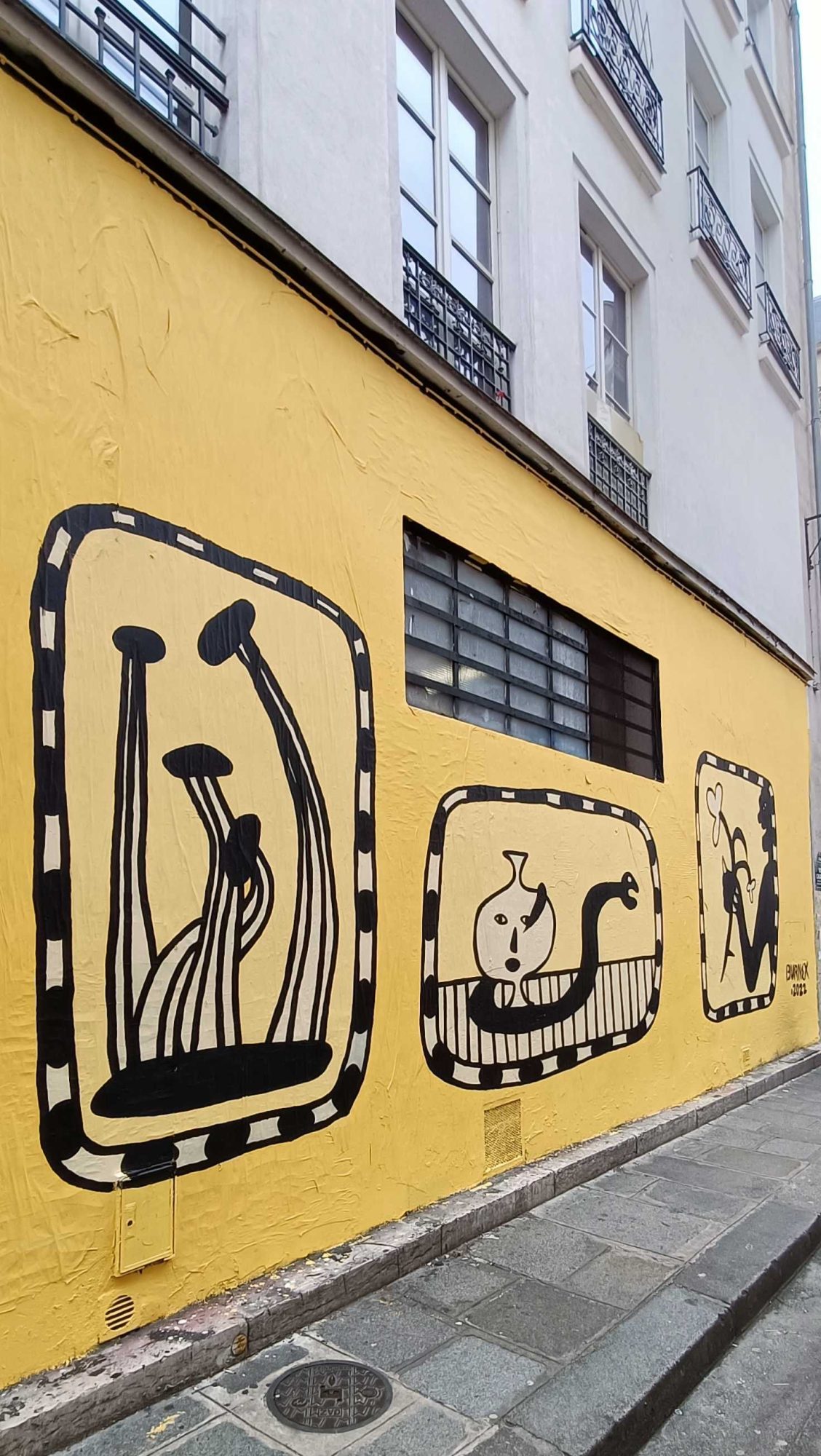 Framed Figures on Yellow Background — Street art in Paris