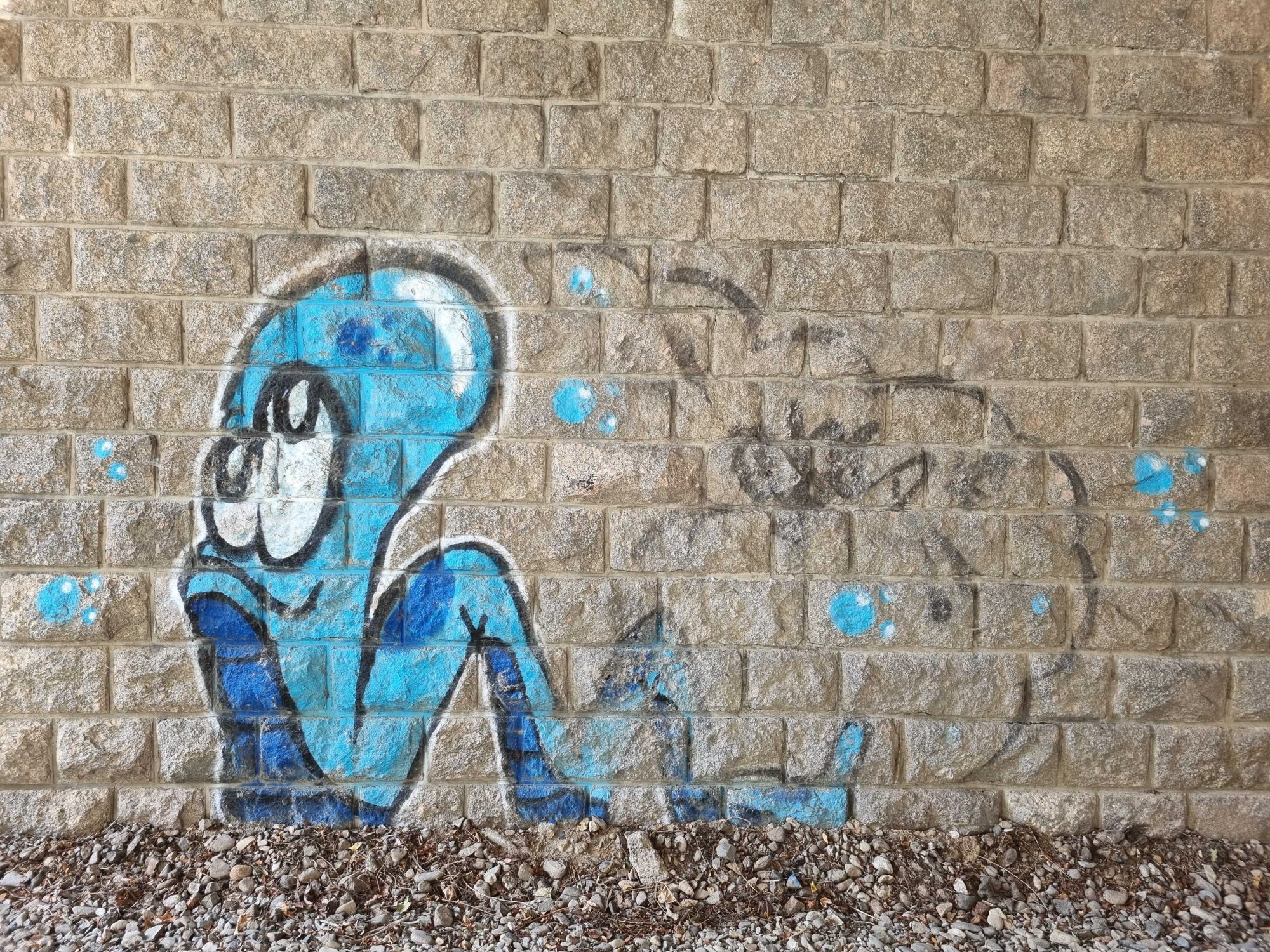 The seated blue character — Street art in Le Mayet-d'École