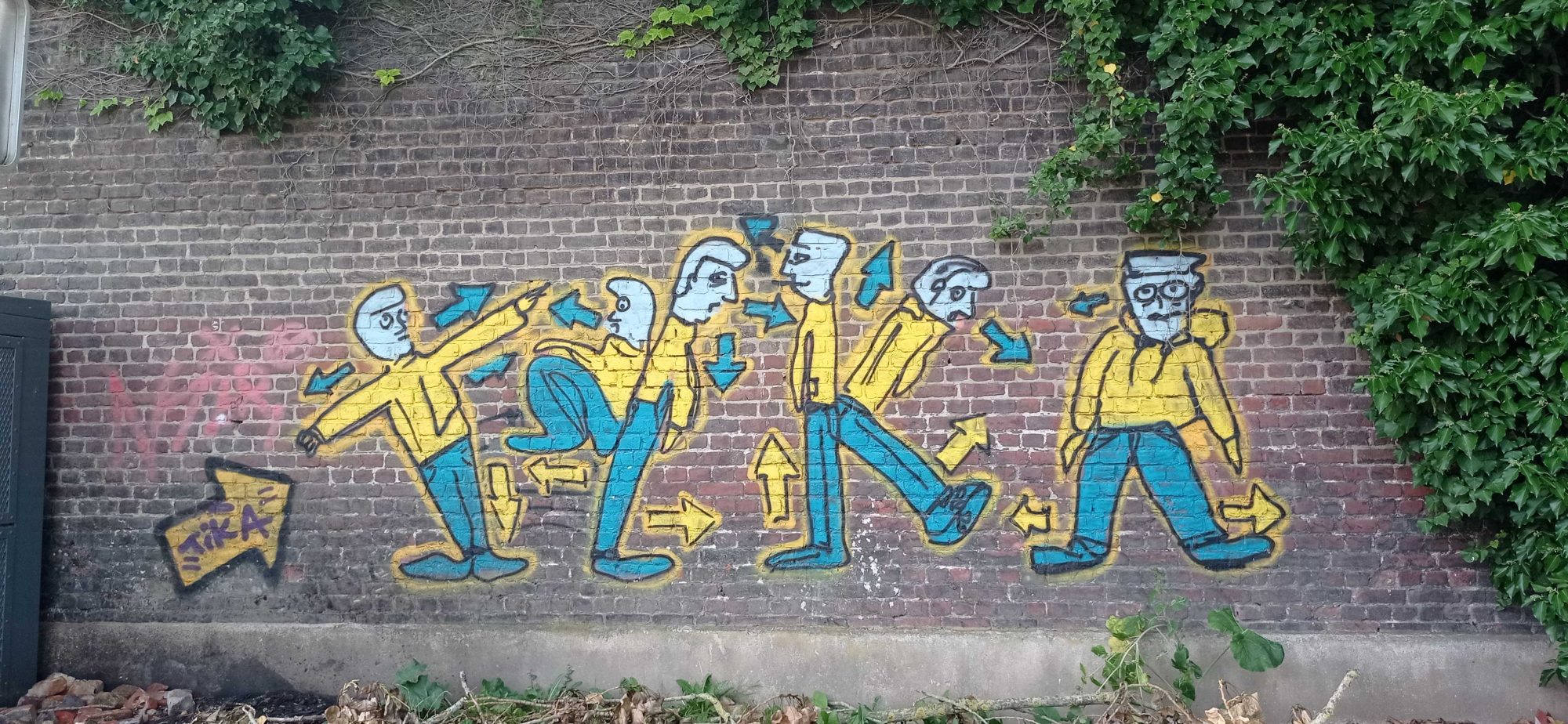 Frieze of men and arrows — Street art in Roubaix