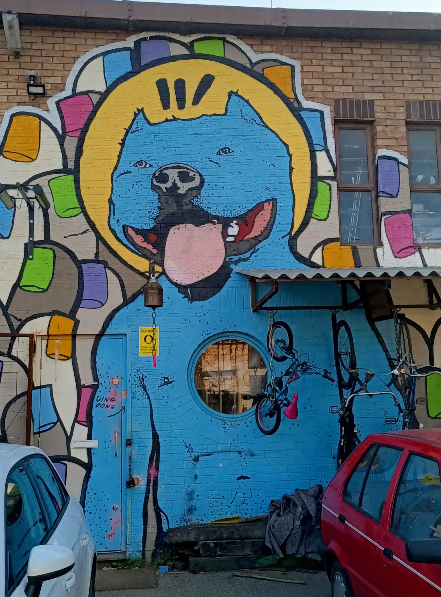 Blue dog with a yellow halo — Street art in London
