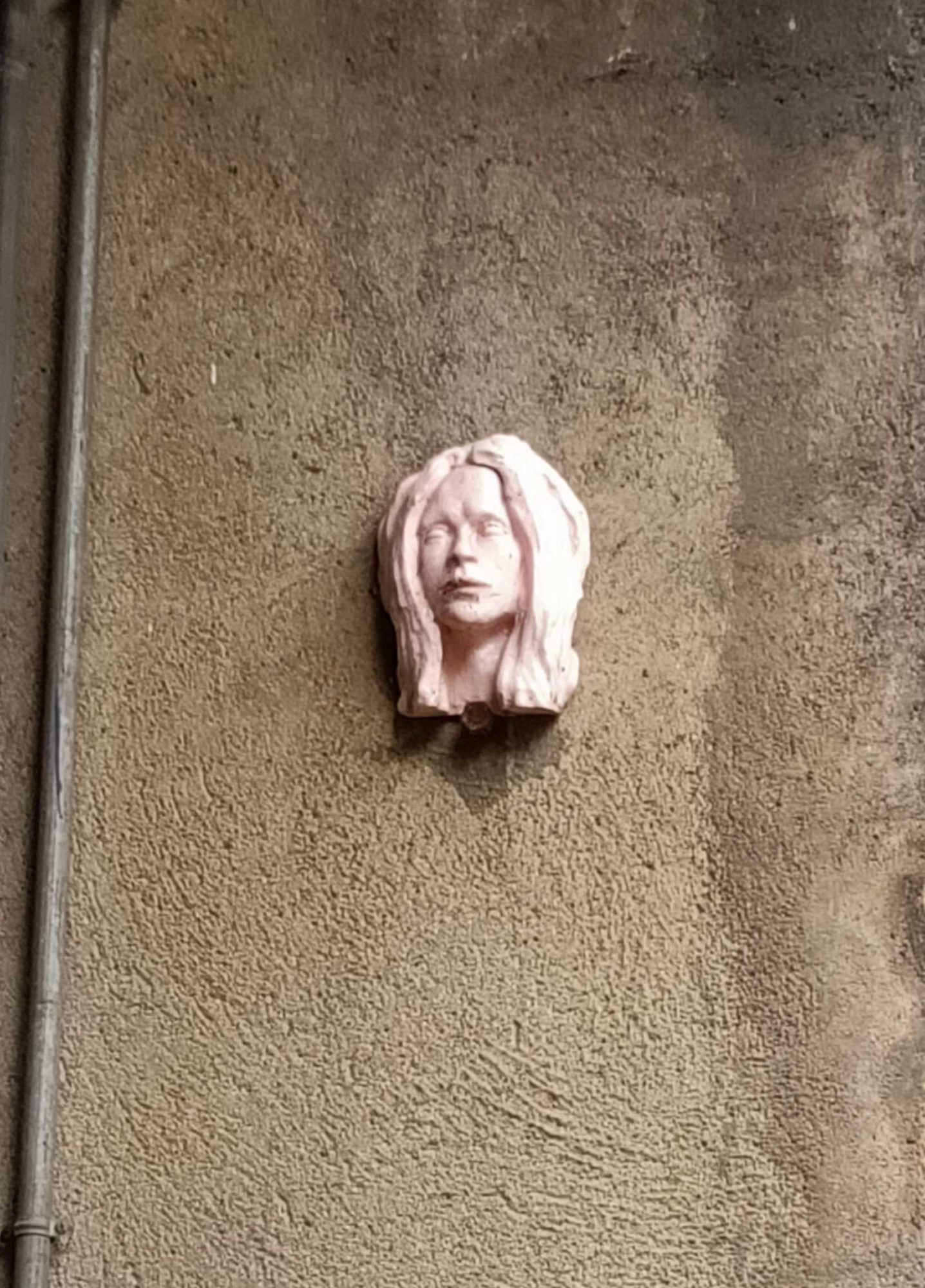 Sculpted Female Face Relief on Wall — Street art in Nantes