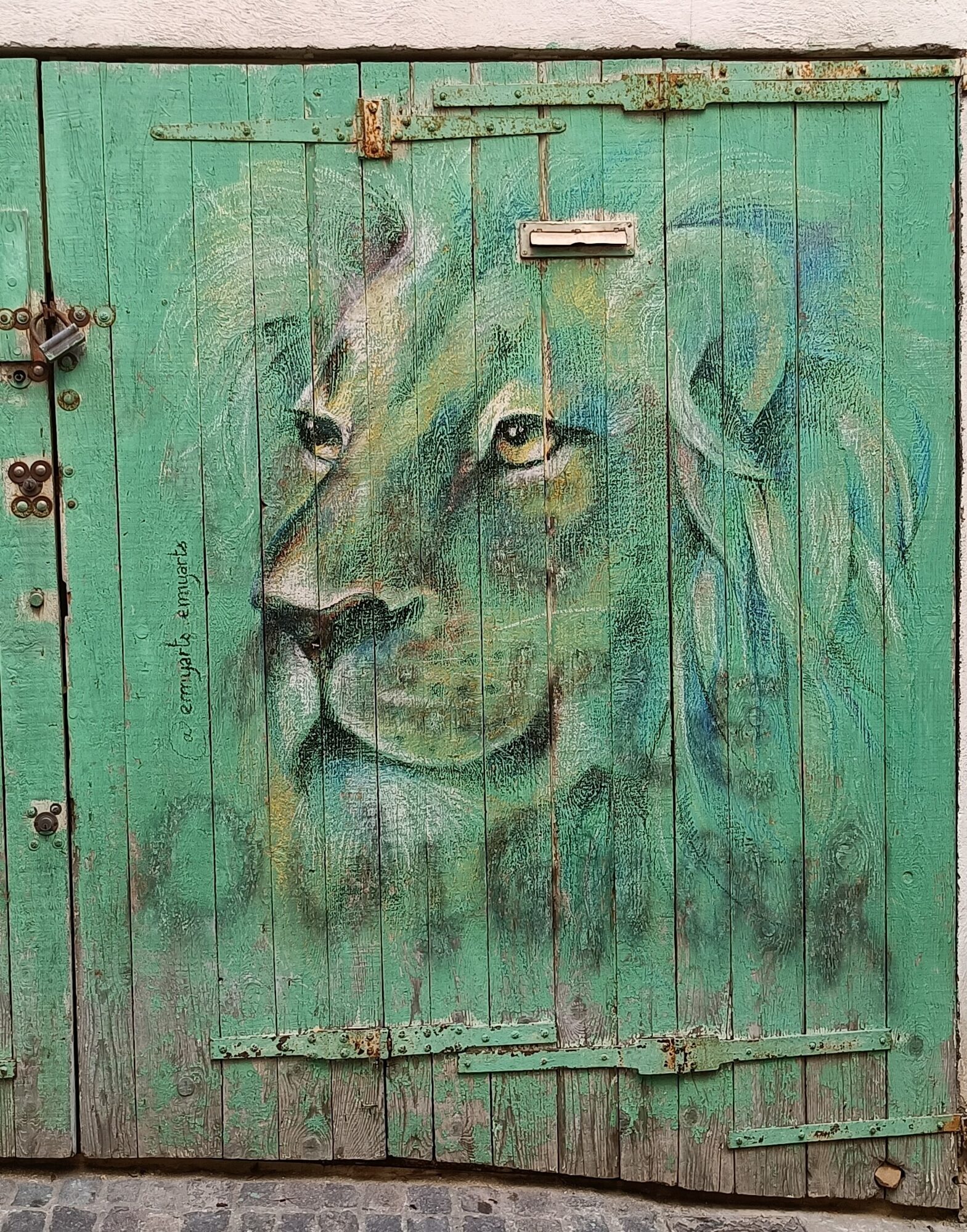 Lion's Head on a Green Door — Street art by emyart in Marseille