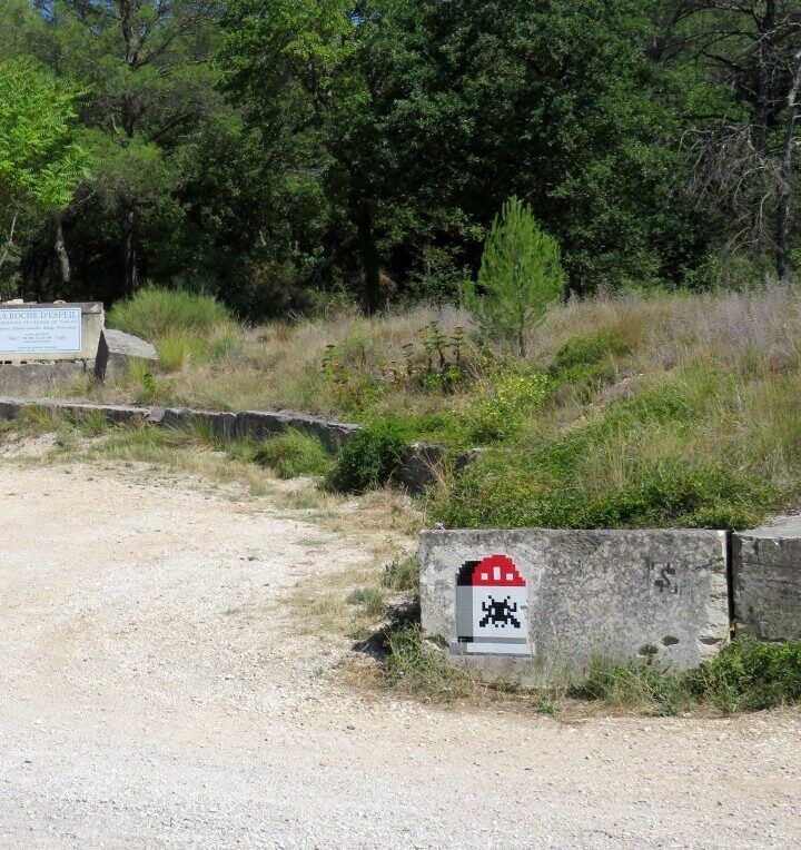 LBR_08, Space Invader on Route de la Combe — Street art by Invader in Buoux